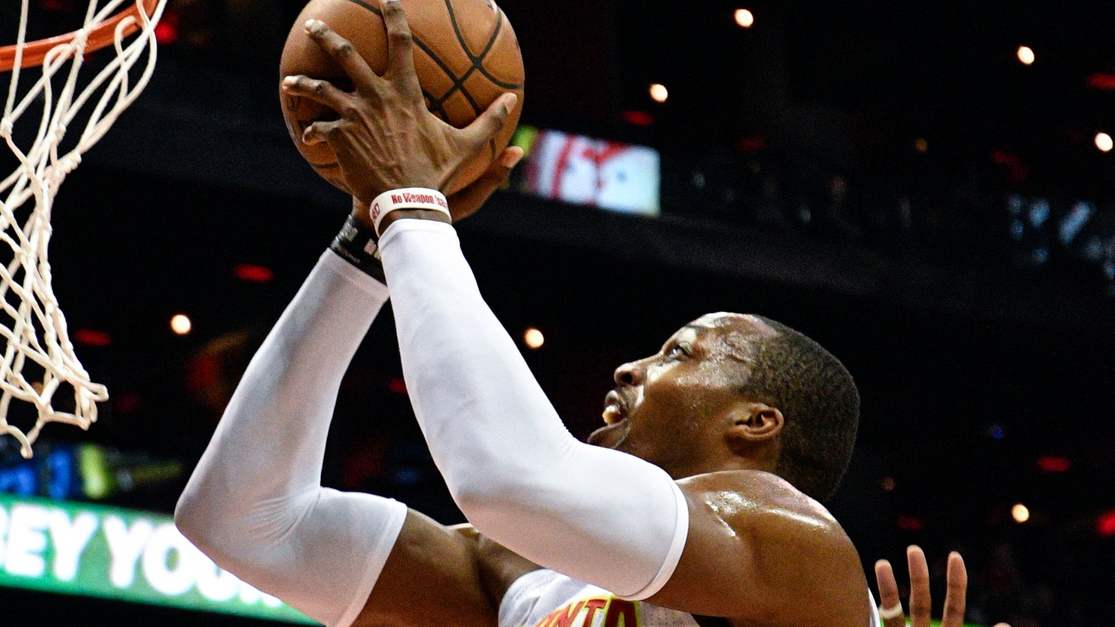 Atlanta Hawks center Dwight Howard (8) shoots as Philadelphia 76ers center Jahlil Okafor defends during the second half of an NBA basketball game, Saturday, Jan. 21, 2017, in Atlanta. Atlanta won 110-93. (AP Photo/John Amis)