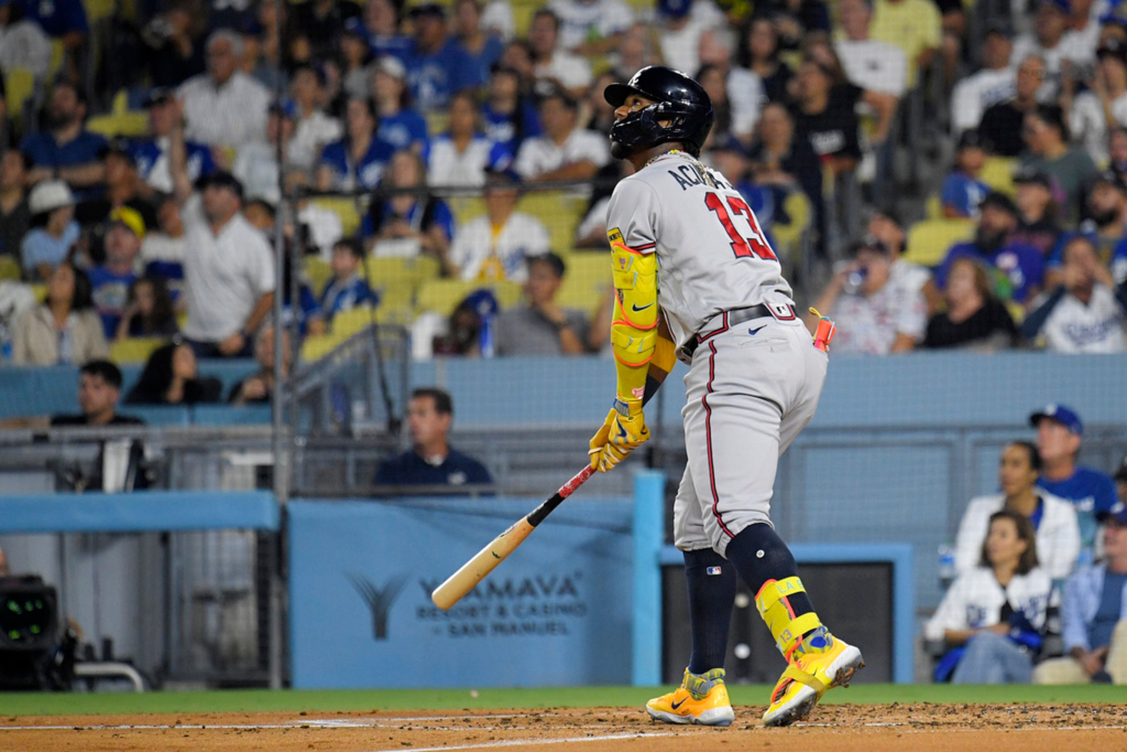 Atlanta Braves' Ronald Acuna Jr., left, heads to first after hitting a solo home run during the third inning of a baseball game against the Los Angeles Dodgers Friday, Sept. 1, 2023, in Los Angeles. (AP Photo/Mark J. Terrill)