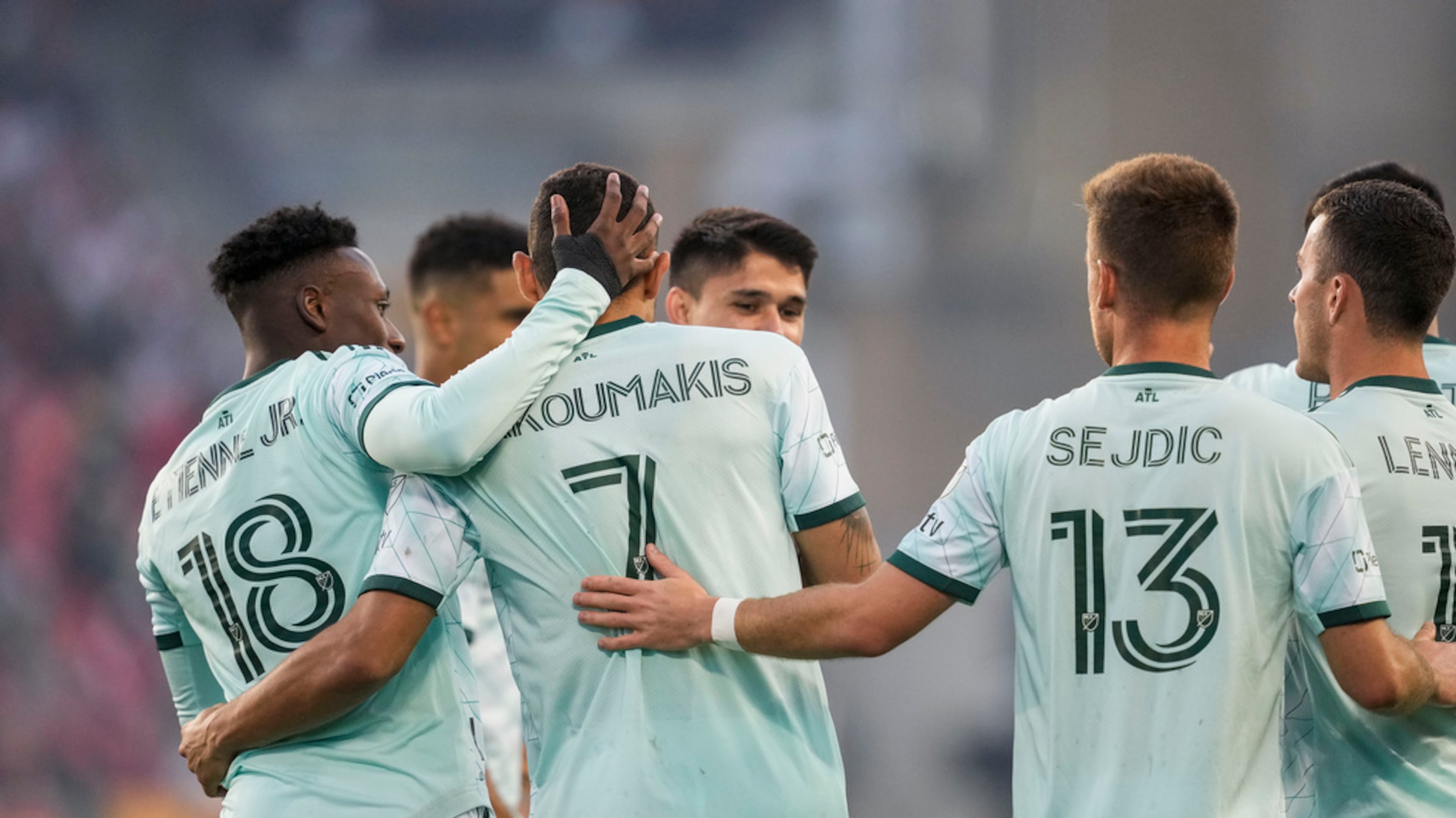 Atlanta United forward Giorgos Giakoumakis (7) celebrates his goal against Toronto FC with midfielder Derrick Etienne (18) and midfielder Amar Sejdic (13) during the first half of an MLS soccer match Saturday, April 15, 2023, in Toronto. (Andrew Lahodynskyj/The Canadian Press via AP)