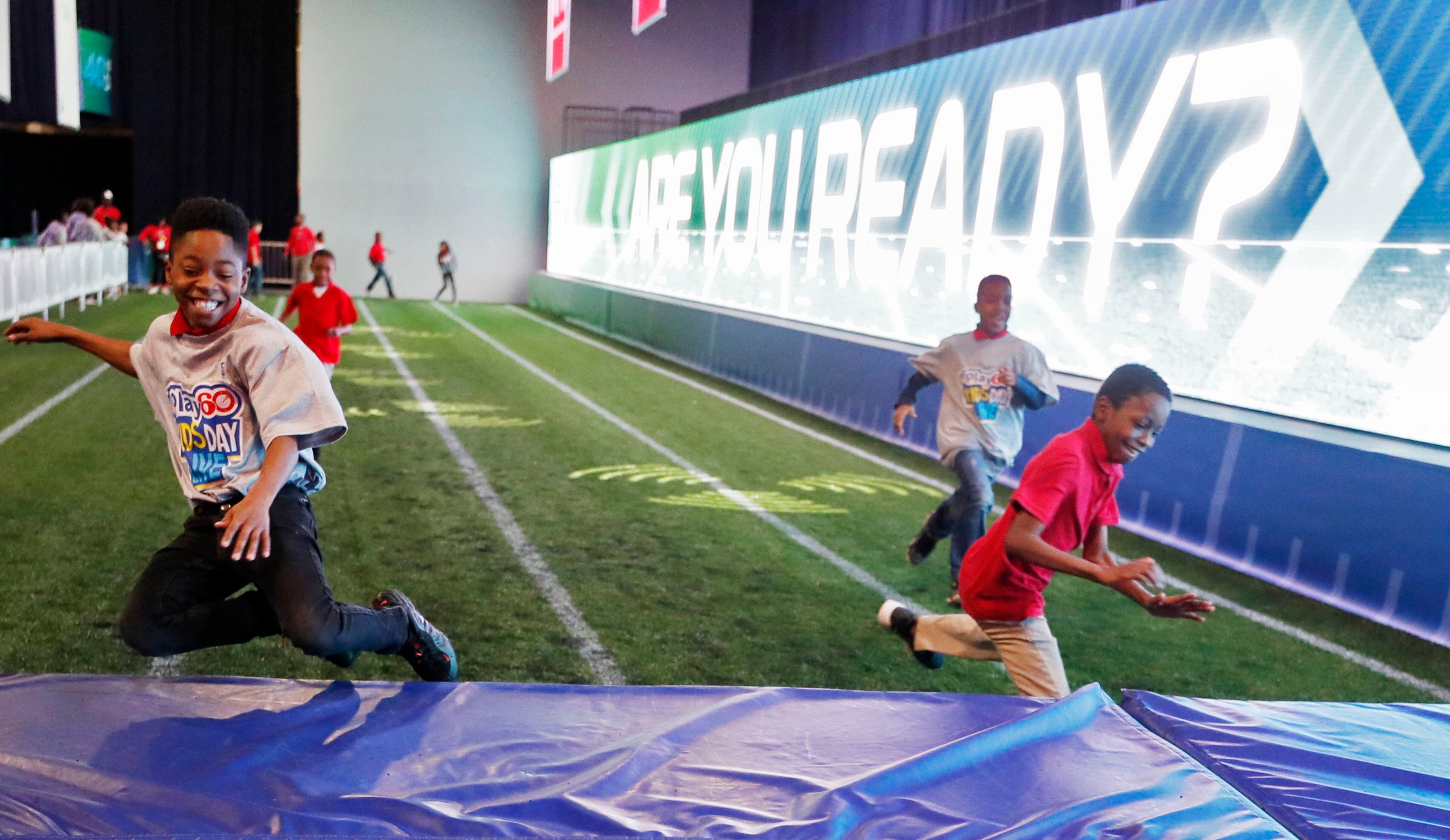 1/30/19 - Atlanta - Students from Marbut Ellementary School in Lithonia crash land at the end of the 40 yard dash attraction. NFL PLAY 60 Kids' Day gave more than 2,000 local youth to spend the day at the Super Bowl Experience. The kids were free to roam through the many attractions at the Georgia World Congress Center. Bob Andres / bandres@ajc.com