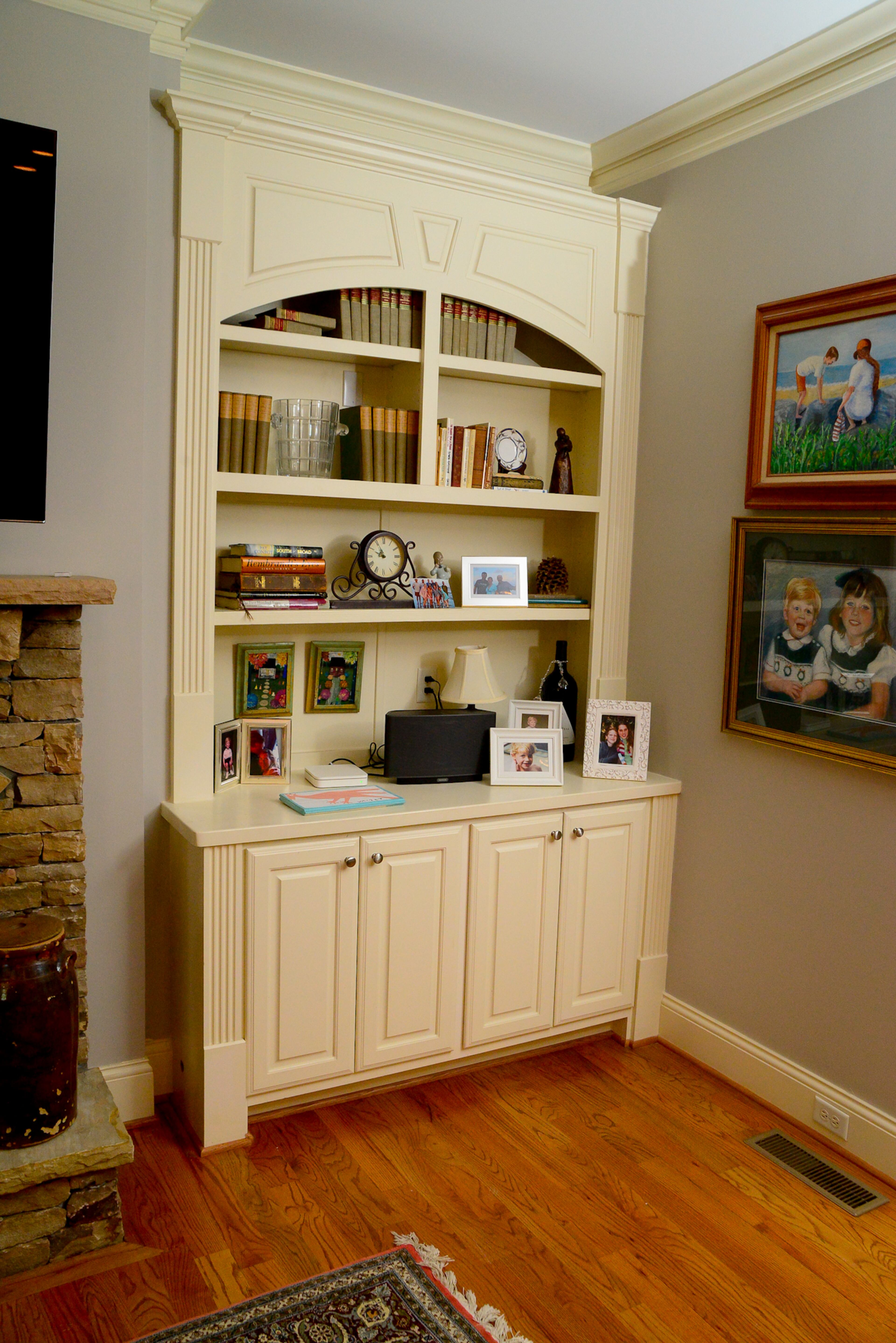 Moldings around built-in bookcases and on the walls add a bit of formality to the townhome, which has open design and abundant antiques and artwork.