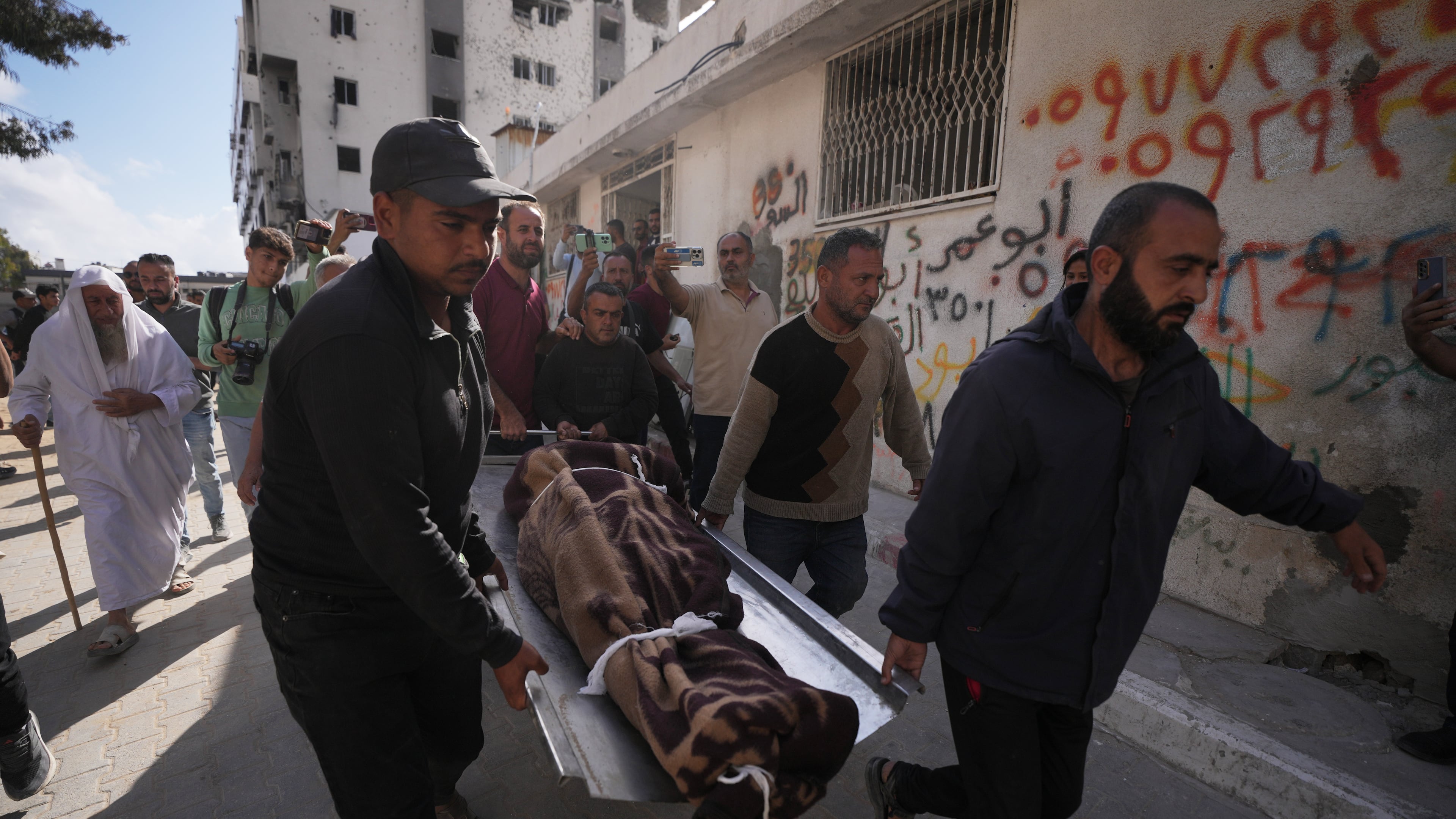 Palestinians carry the body of a person killed in Israeli airstrikes Friday targeting Izz al-Din al-Haddad, the leader of Hamas’ Qassam Brigades, during a funeral outside Shifa Hospital in Gaza City, Saturday, May 16, 2026. (AP Photo/Jehad Alshrafi)