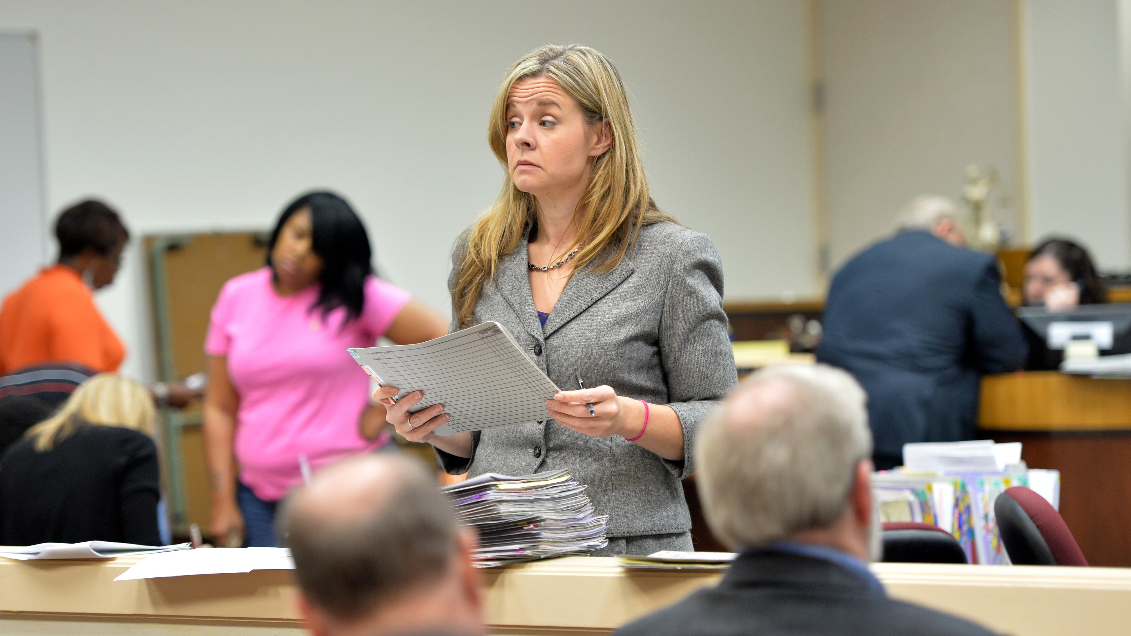 June 20, 2013 Marietta - Melissa Rife (center), assistant solicitor general, calls one of misdemeanor defendants in the audience during a criminal arraignment at Cobb County State Court in Marietta on Thursday, June 20, 2013. State Court caseloads have plummeted in many metro Atlanta counties since 2010 - a result of a filing fee hike that caused many civil cases to migrate to Magistrate Court, where jurisdiction overlaps but filing fees are cheaper. HYOSUB SHIN / HSHIN@AJC.COM
