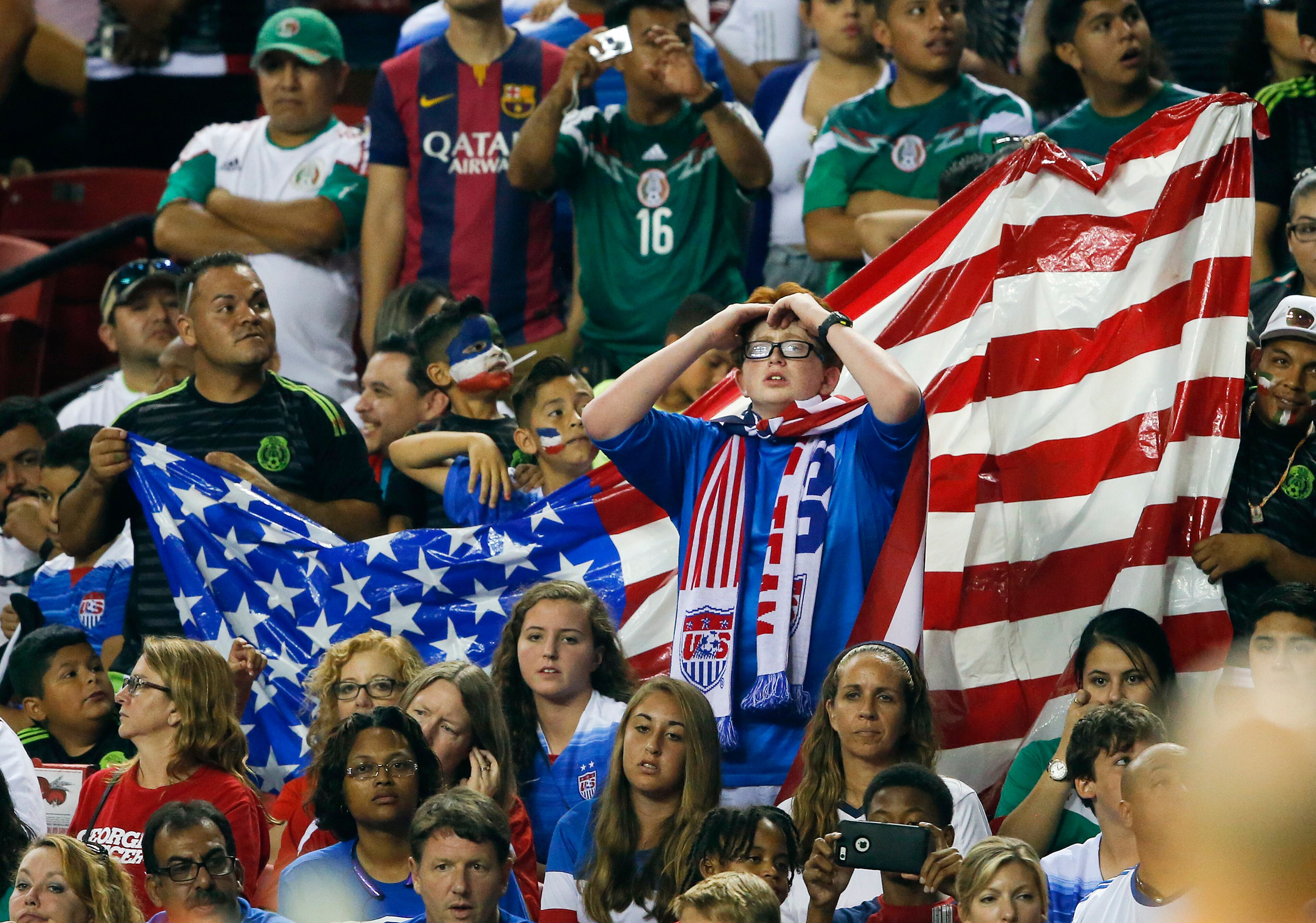 U.S. soccer fans watch during the final moments of the team's CONCACAF Gold Cup soccer semifinal against Jamaica on Wednesday, July 22, 2015, in Atlanta. Jamaica won 2-1. (AP Photo/John Bazemore)