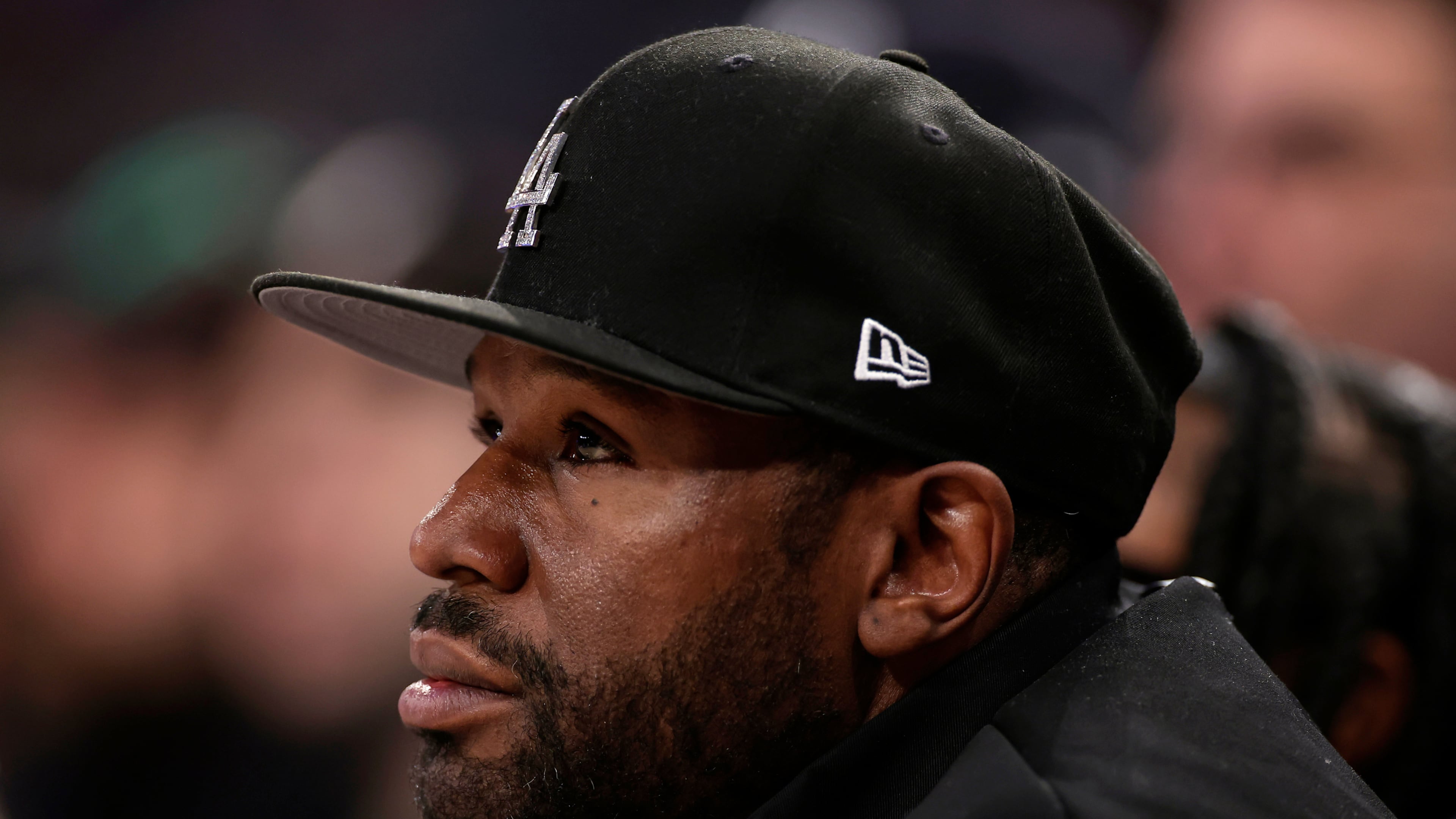 FILE - Boxer Floyd Mayweather Jr. looks on during the first half of an NBA basketball game, March 26, 2025, in New York. (AP Photo/Adam Hunger, File)