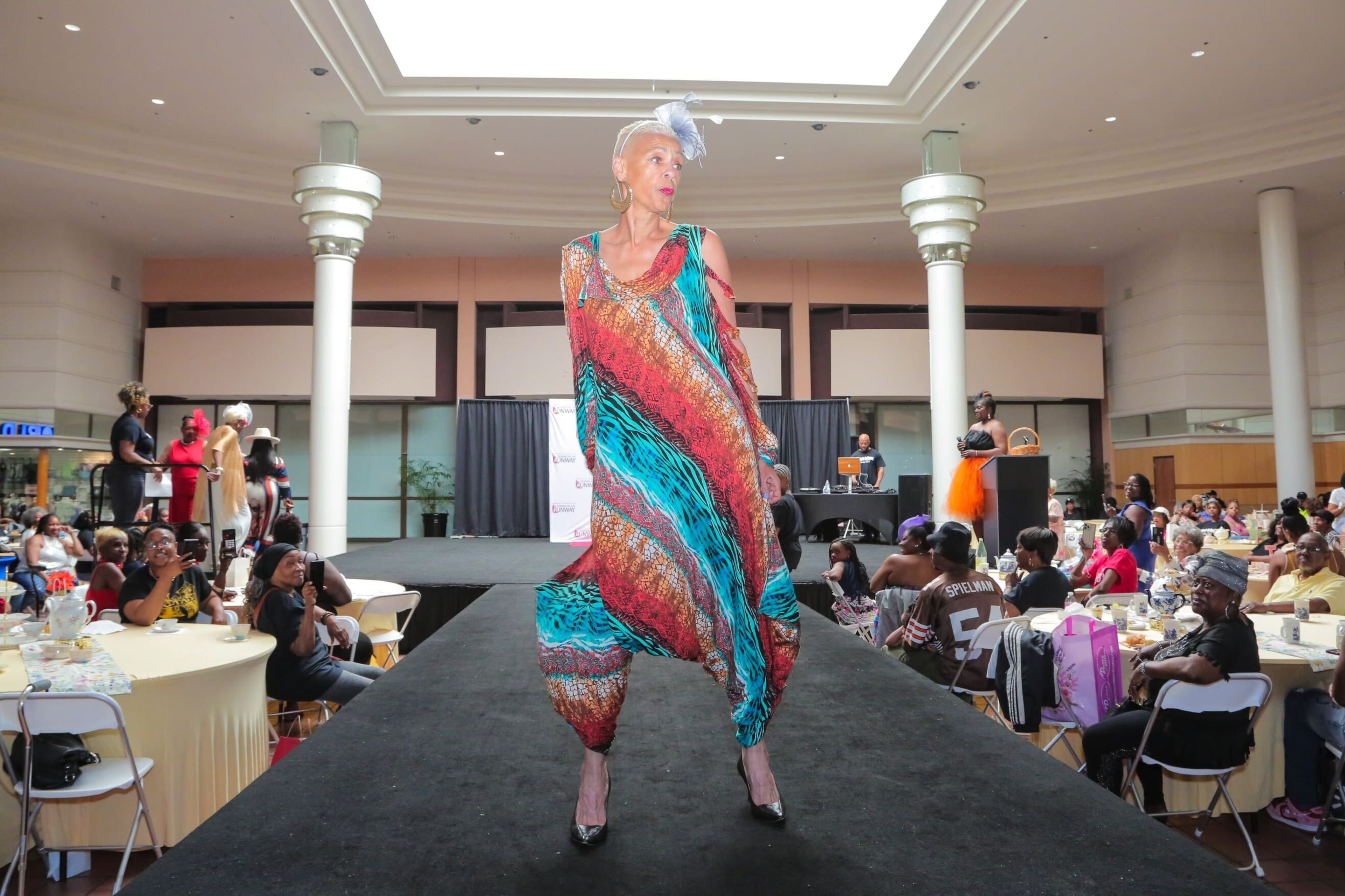 A model wearing a colorful dress struts on the catwalk at the 'Seniors on the Runway' event on May 4, 2024, at Greenbriar Mall in Atlanta. (Emily Heath)