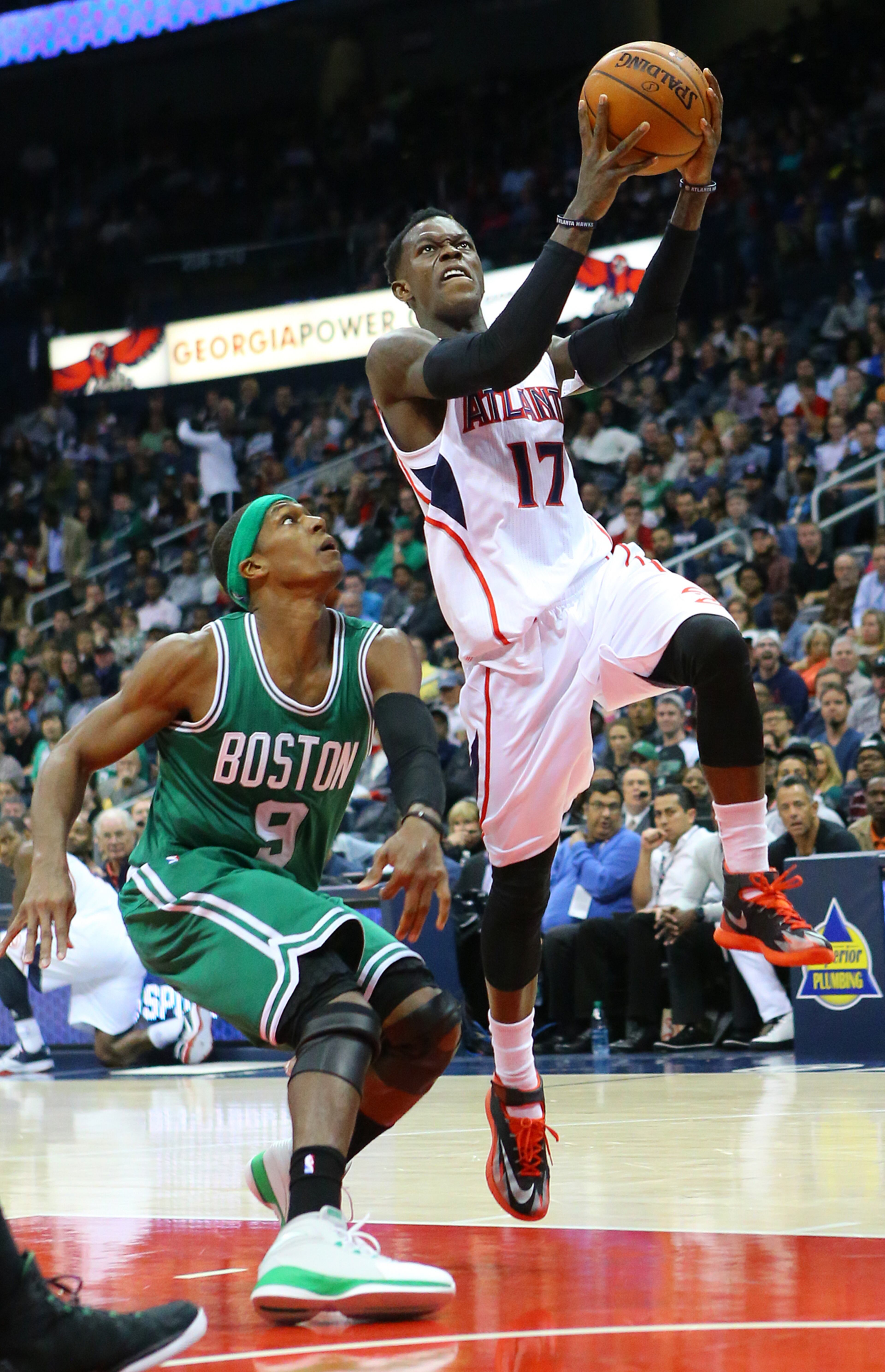 Hawks guard Dennis Schroder drives to the basket past Celtics Rajon Rondo for 2 points leading the Hawks to a come from behind 109-105 victory in the second half of an NBA basketball game on Tuesday, Dec. 2, 2014, in Atlanta. CURTIS COMPTON / CCOMPTON@AJC.COM