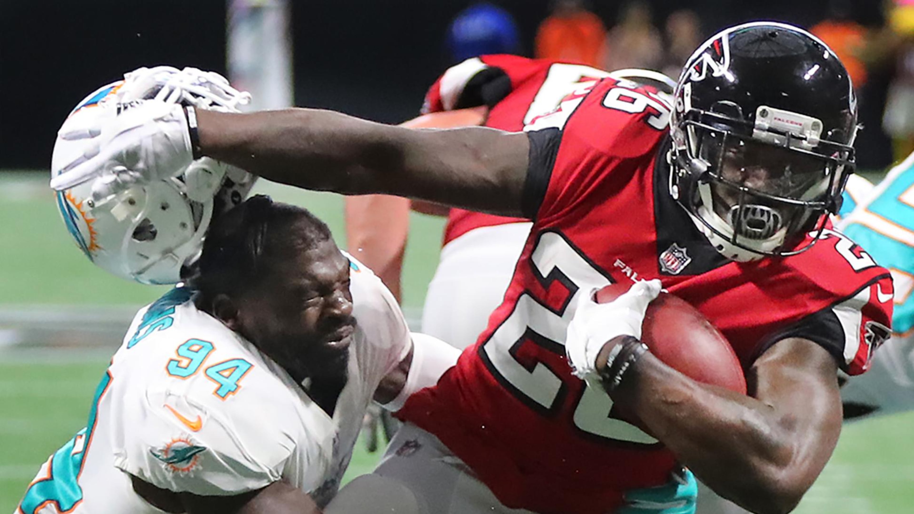 October 15, 2017 Atlanta: Falcons running back Tevin Coleman seperates Miami linebacker Lawrence Timmons from his helmet as he breaks the tackle to run for a touchdown taking a 17-0 lead during the second half in a NFL football game on Sunday, October 15, 2017, in Atlanta. Curtis Compton/ccompton@ajc.com
