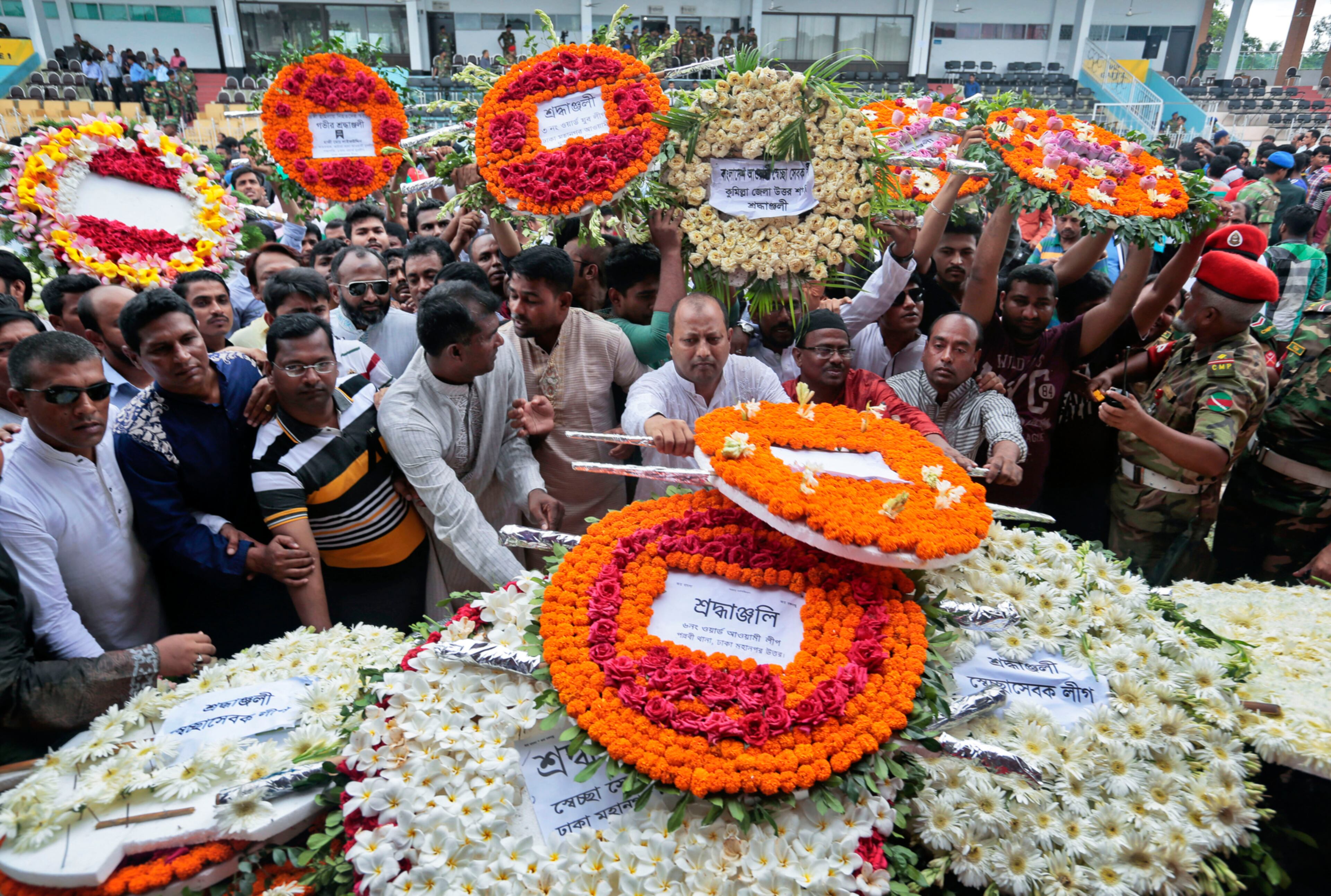 BANGLADESH ATTACK MOURNED--Local residents pay their respects to the victims of the attack at the Holey Artisan Bakery at a stadium in Dhaka, Bangladesh, Monday, July 4, 2016. The assault on the restaurant in Dhaka's diplomatic zone by militants who took dozens of people hostage marks an escalation in militant violence in the Muslim-majority nation. (AP Photo)