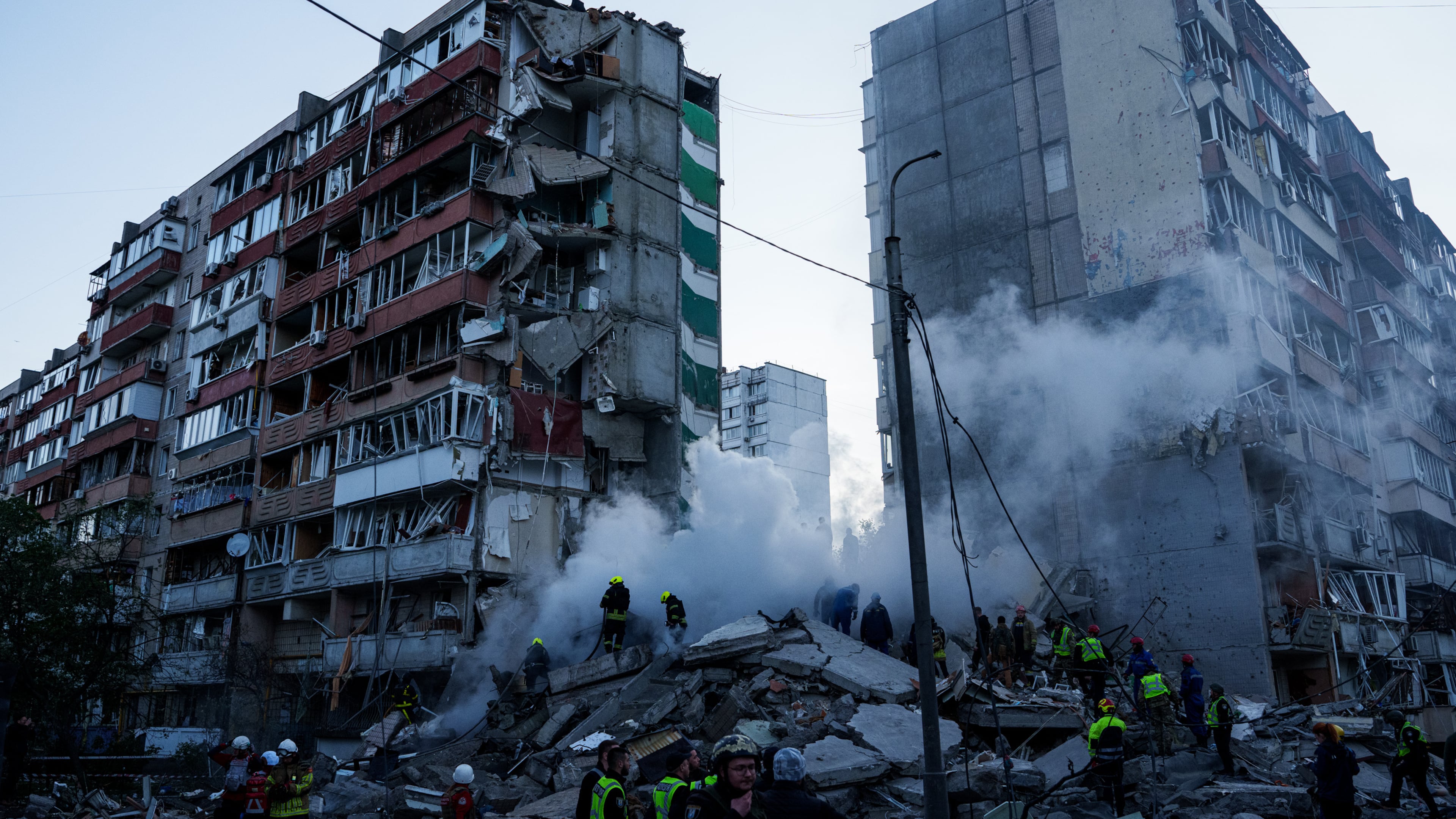Rescue workers clear the rubble of a house heavily damaged after a Russian strike on a residential neighborhood in Kyiv, Ukraine, on Thursday, May 14, 2026. (AP Photo/Evgeniy Maloletka)