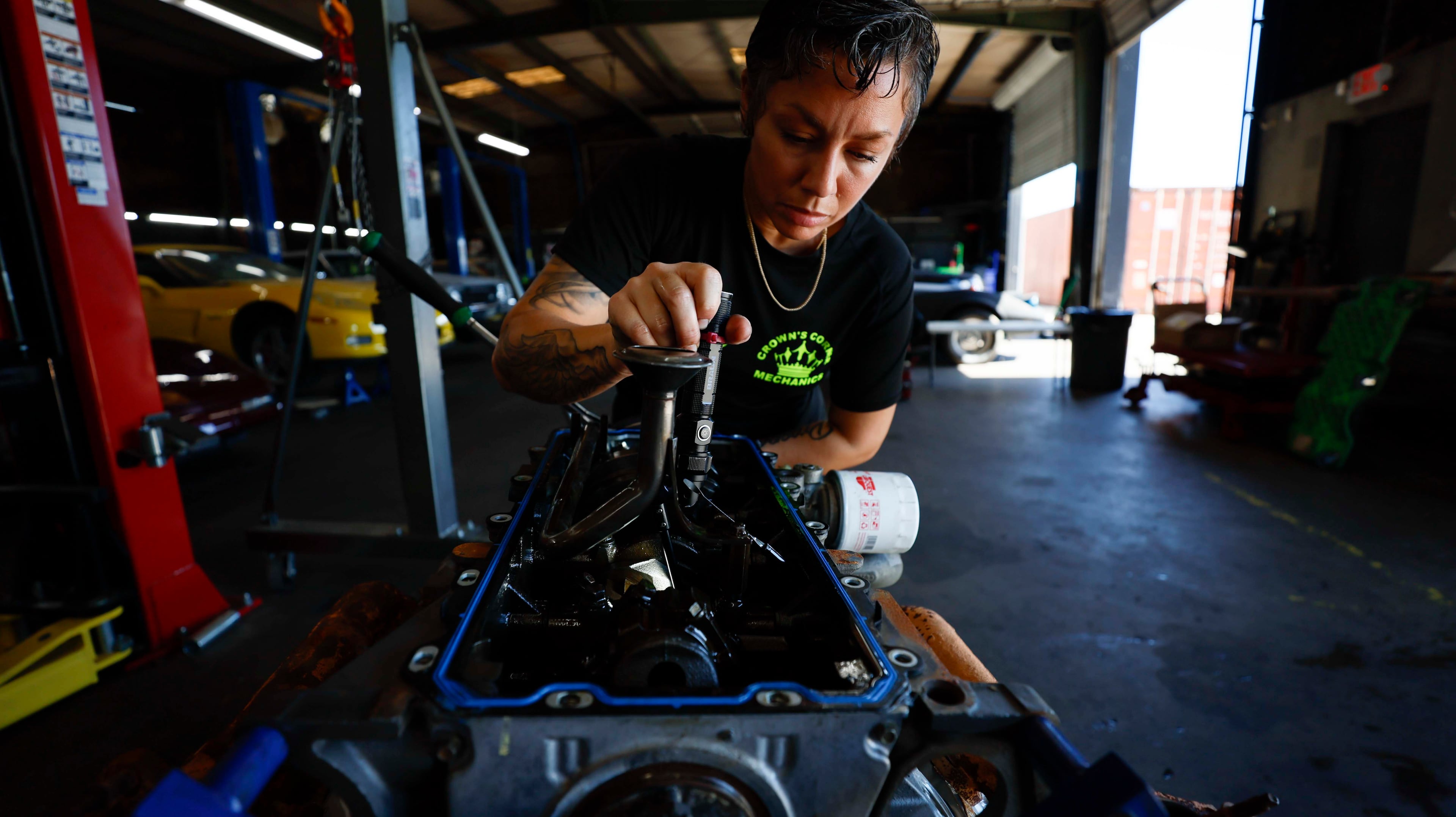 Desiree White, owner of Crown’s Corner Mechanics, works on a Ford F-150 engine at her Conyers shop on Thursday, June 4, 2026. (Miguel Martinez/AJC)