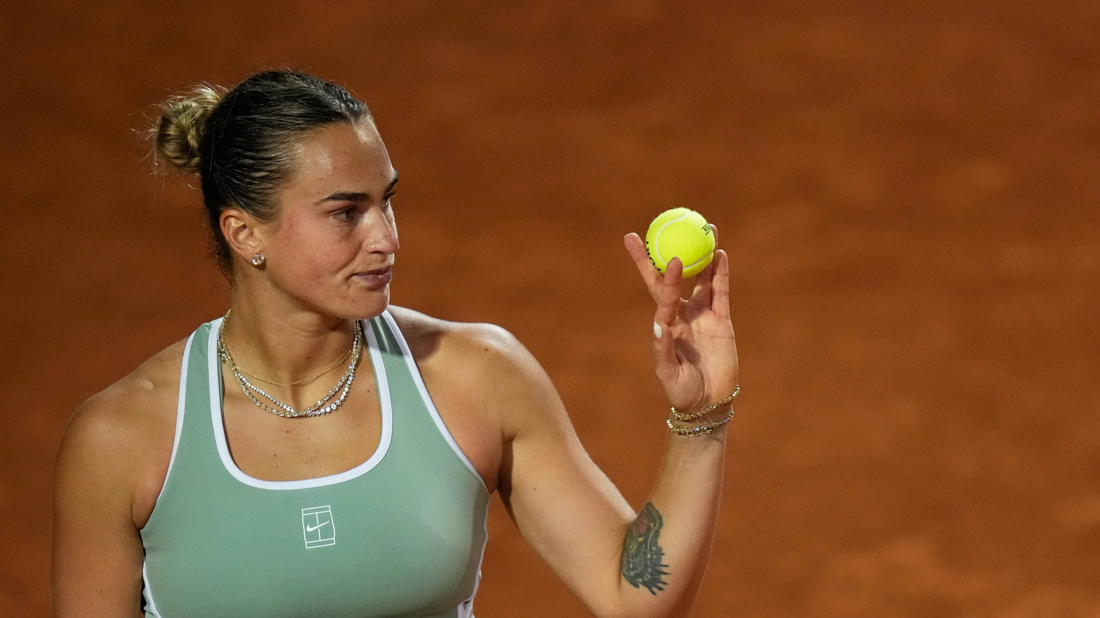 Aryna Sabalenka, of Belarus, prepares to serve the ball to Barbora Krejcikova, of Czechia, during their match at the Italian Open tennis tournament in Rome, Thursday, May 7, 2026. (AP Photo/Alessandra Tarantino)