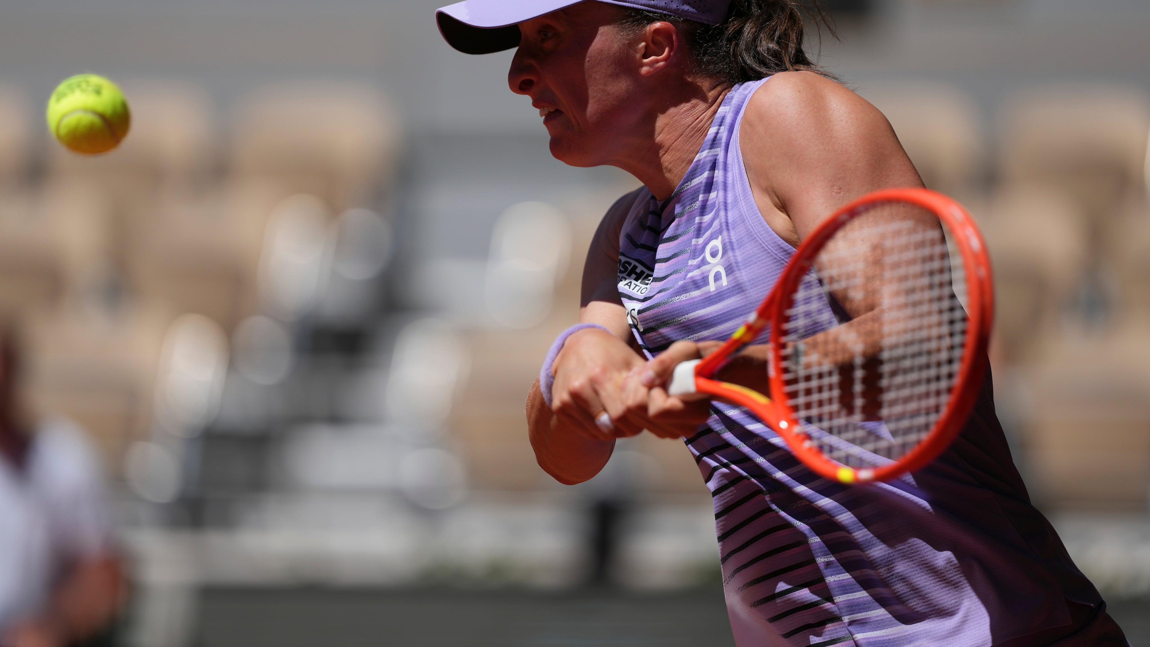 Iga Swiatek of Poland returns to Sara Bejlek of the Czech Republic during their second round women's singles tennis match at the French Open tennis tournament in Paris, Wednesday, May 27, 2026. (AP Photo/Thibault Camus)