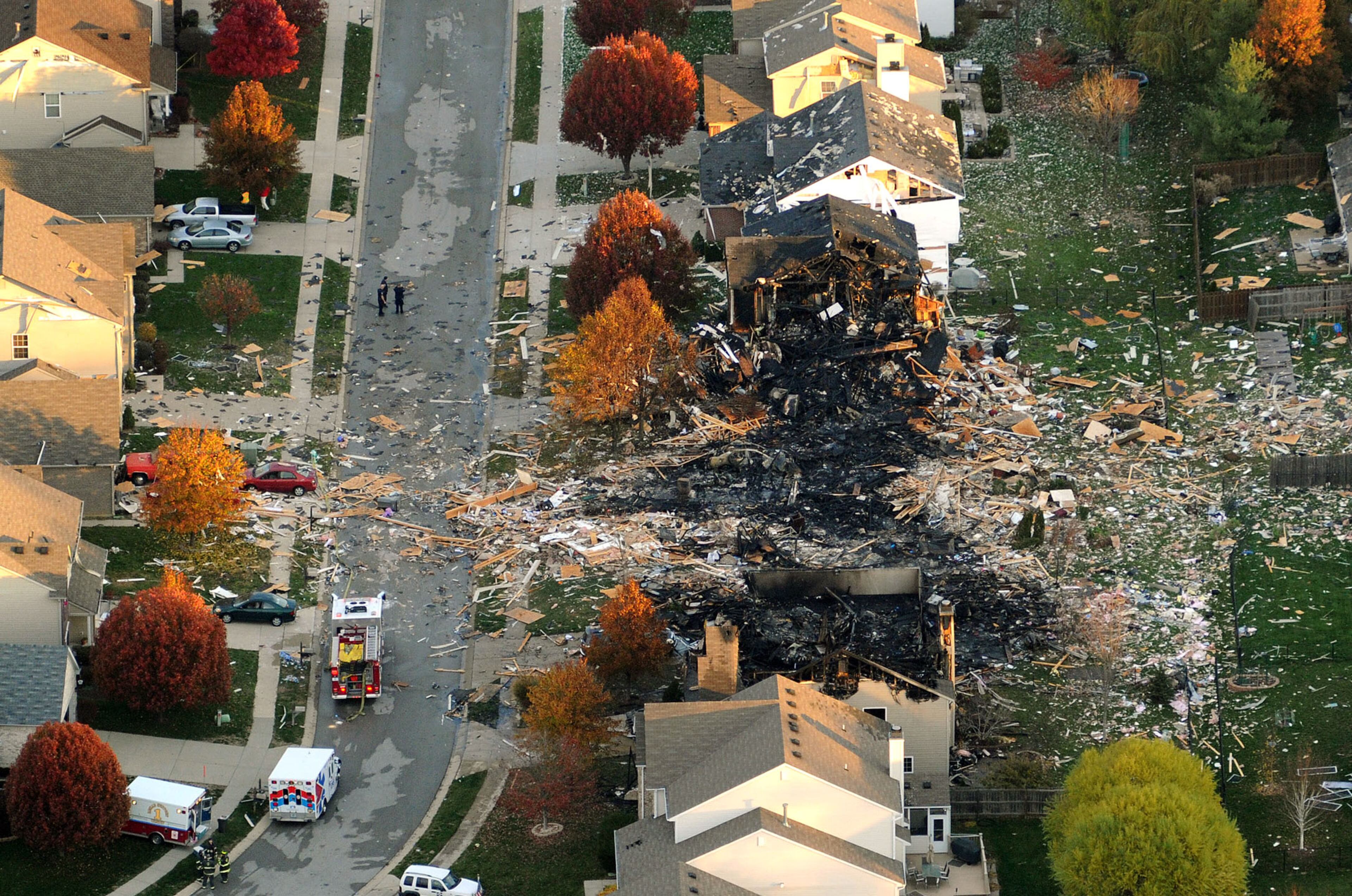 This aerial photo shows the two homes that were leveled and the numerous neighboring homes that were damaged from a massive explosion that sparked a huge fire and killed two people, Sunday in Indianapolis. Nearly three dozen homes were damaged or destroyed, and seven people were taken to a hospital with injuries, authorities said Sunday. The powerful nighttime blast shattered windows, crumpled walls and could be felt at least three miles away.