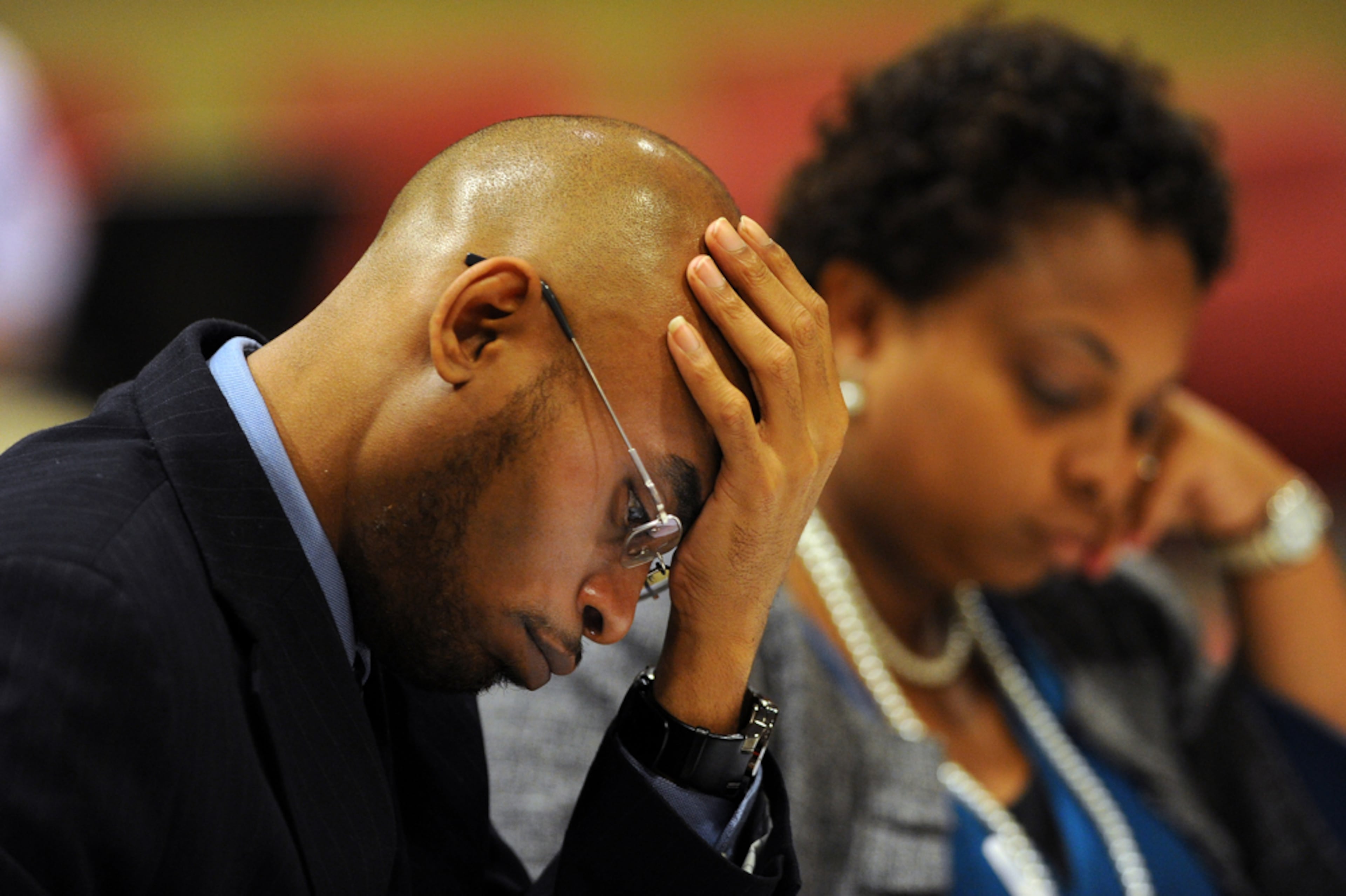 APS TRIBUNAL--Former Finch Elementary school teacher Curtis Collier puts his hand on his head as Atlanta Public Schools Superintendent Erroll B Davis, Jr. testifies against him during the APS tribunal at Atlanta Public School headquarters on Tuesday, September 11,2012. This is the second day of the hearing. During the first day of the hearing Thomas-Collier denied allegations of state investigators that he stayed after school to help other teachers at Finch erase and correct answers.
