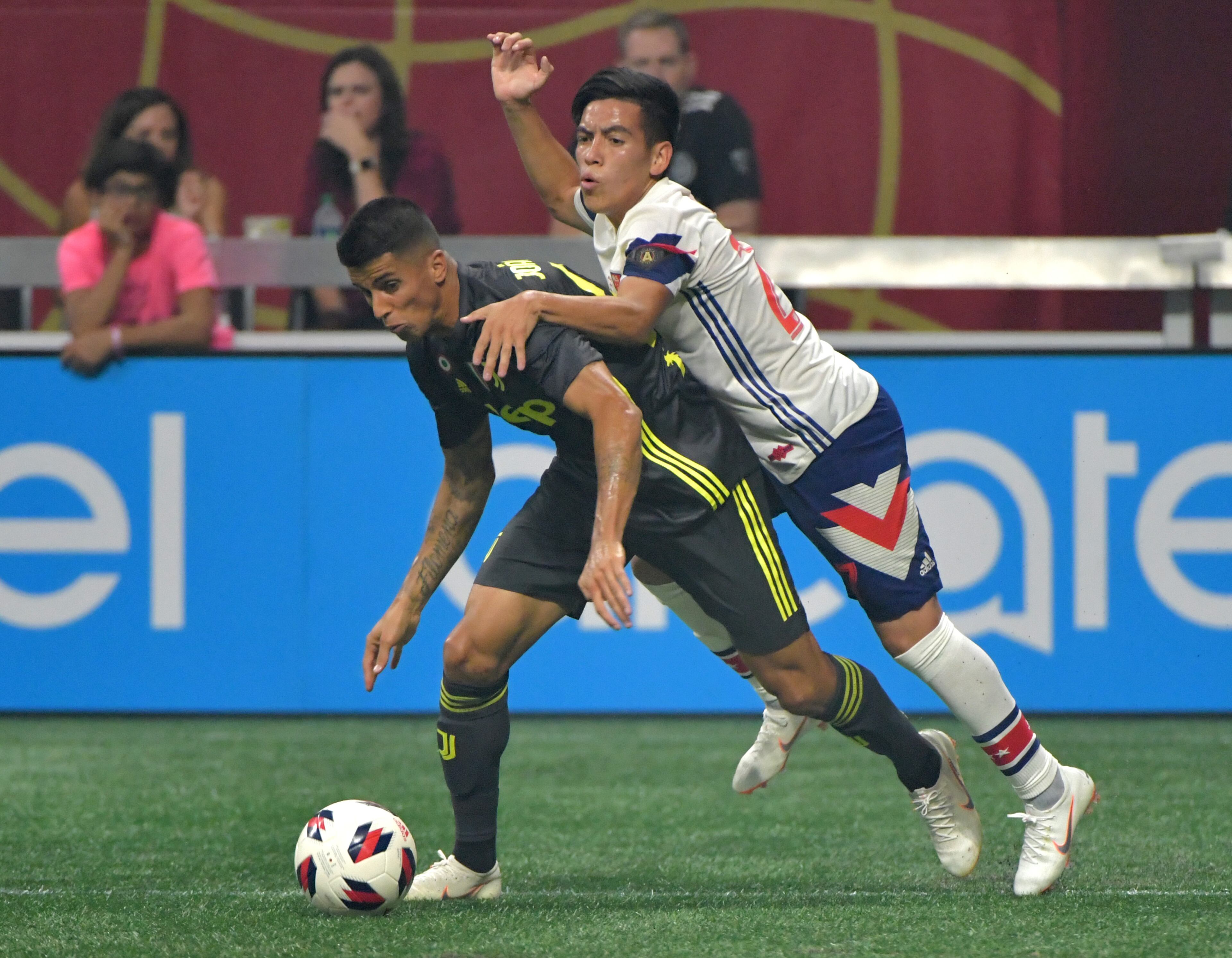 Juventus defender Joao Cancelo (left) and MLS All-Stars midfielder Ezequiel Barco (27) battle for the ball in the second half of the Major League Soccer All-Star Game at the Mercedes-Benz Stadium on Wednesday, August 1, 2018. Juventus won 2-1 over the MLS All-Stars after penalty shootout. HYOSUB SHIN / HSHIN@AJC.COM