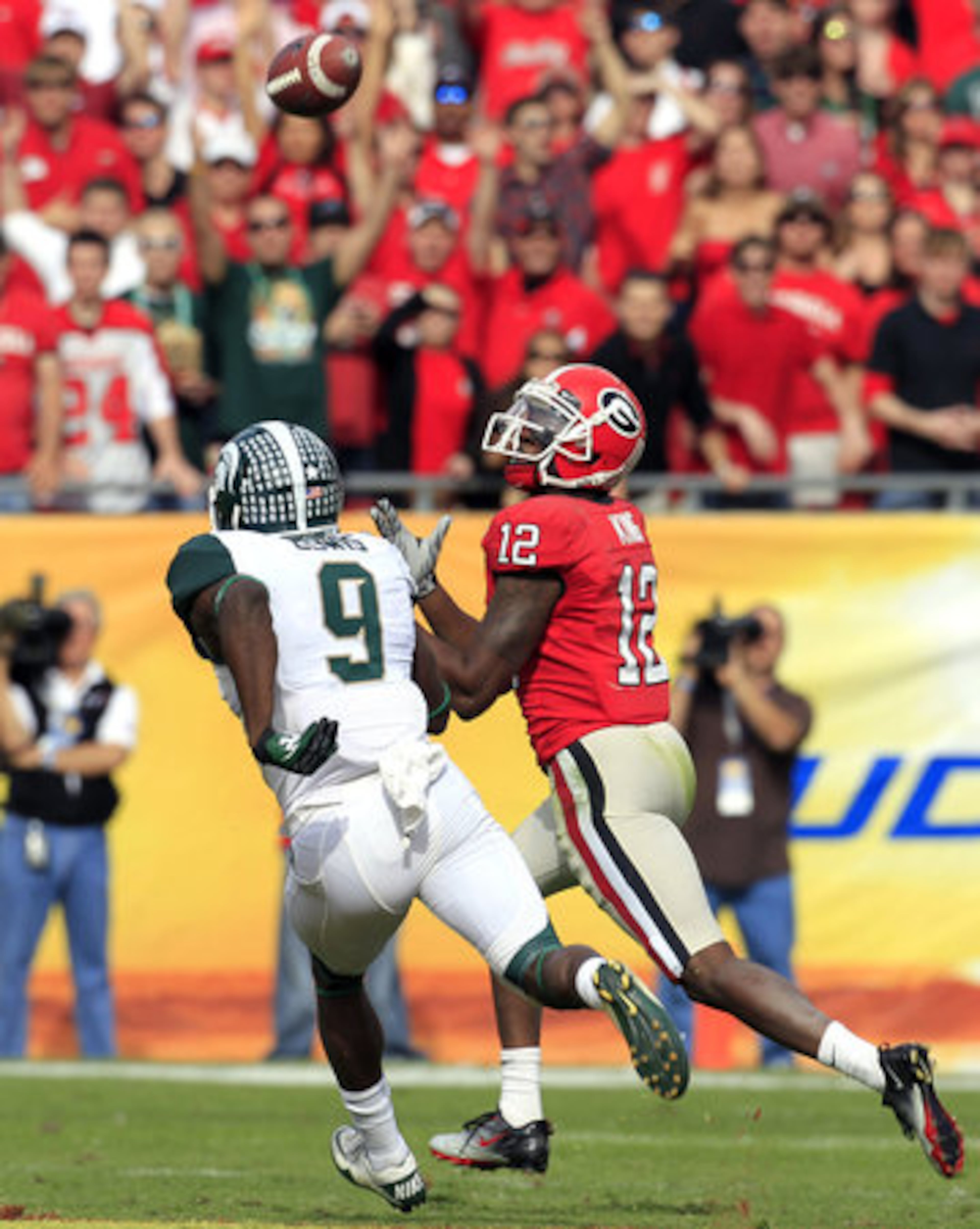 Georgia wide receiver Tavarres King (12) pulls in an 80-yard touchdown reception in front of Michigan State safety Isaiah Lewis (9) during the second quarter of the Outback Bowl, Monday, Jan. 2, 2012, in Tampa, Fla.