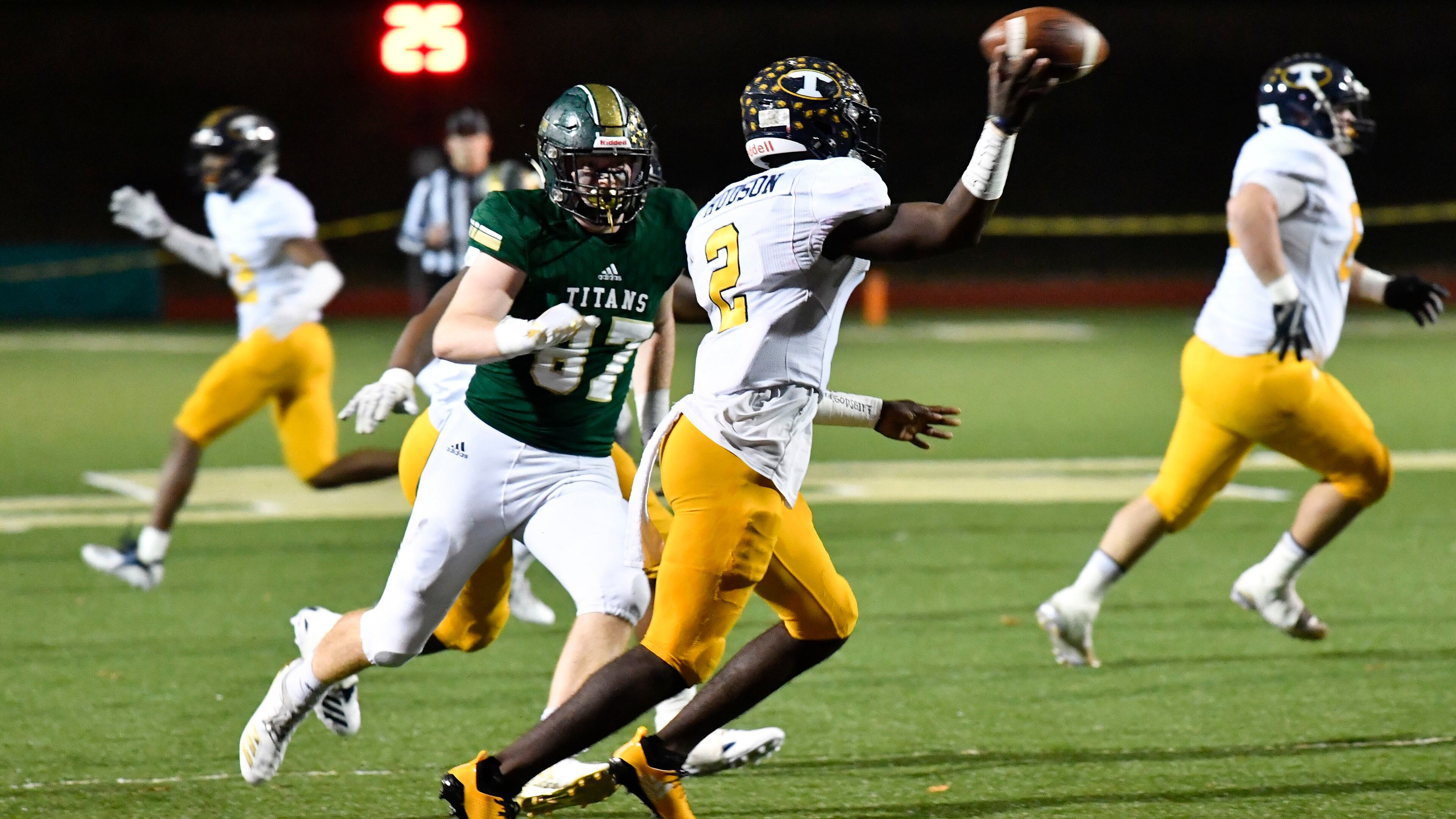 High school football: Troup County's Kobe Hudson looks to pass as Blessed Trinity DE Grayson Gilder (87) defends during Friday's Class AAAA state semifinal game in Roswell. (John Amis/Special)
