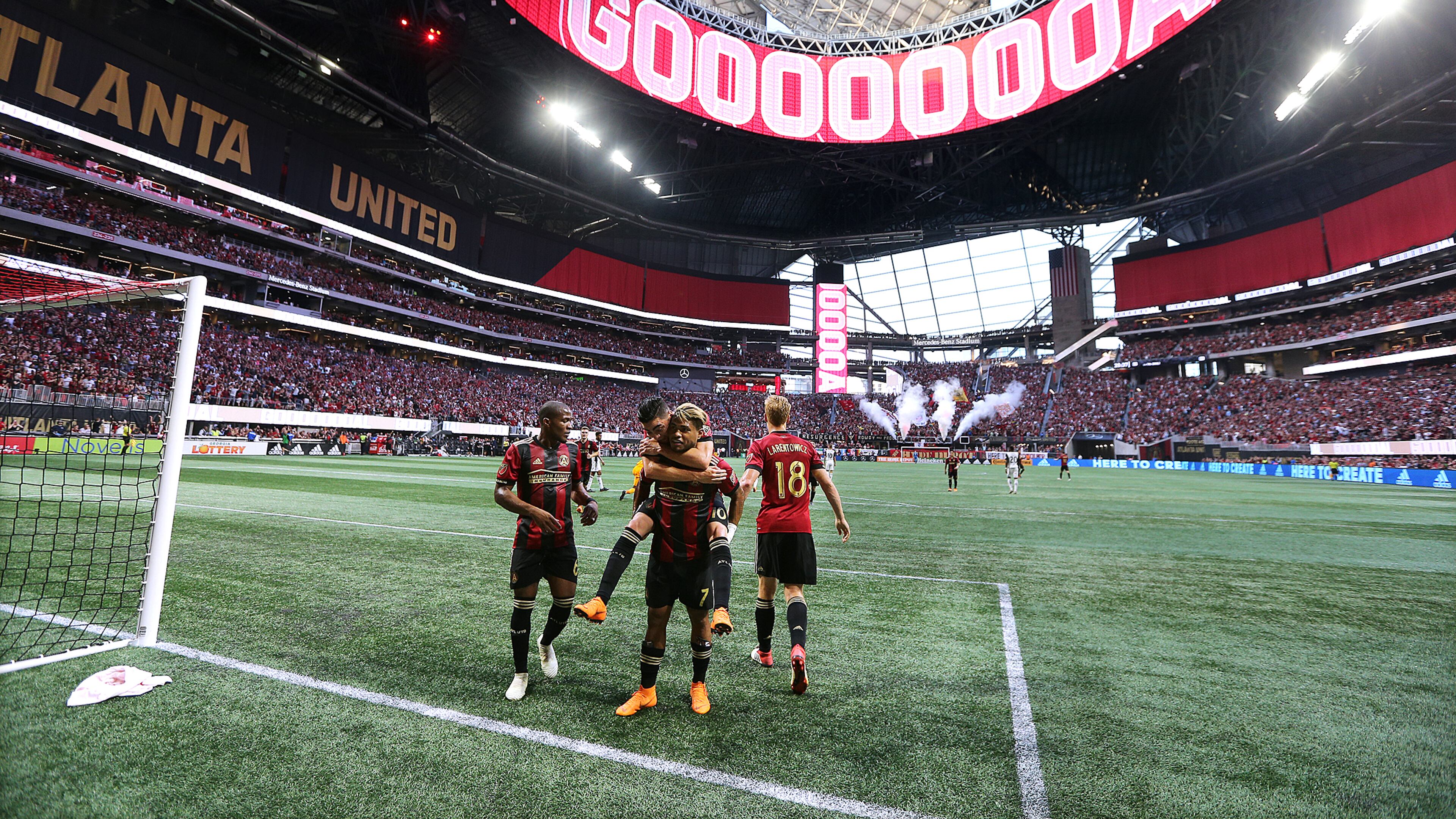 June 2, 2018 Atlanta: The roof of Mercedes-Benz Stadium is open as Atlanta United forward Josef Martinez celebrates his goal on a penalty kick with teammates while Miguel Almiron jumps on his back for a 1-0 lead against Philadelphia Union during the first half in a MLS soccer match on Saturday, June 2, 2018, in Atlanta. Curtis Compton/ccompton@ajc.com