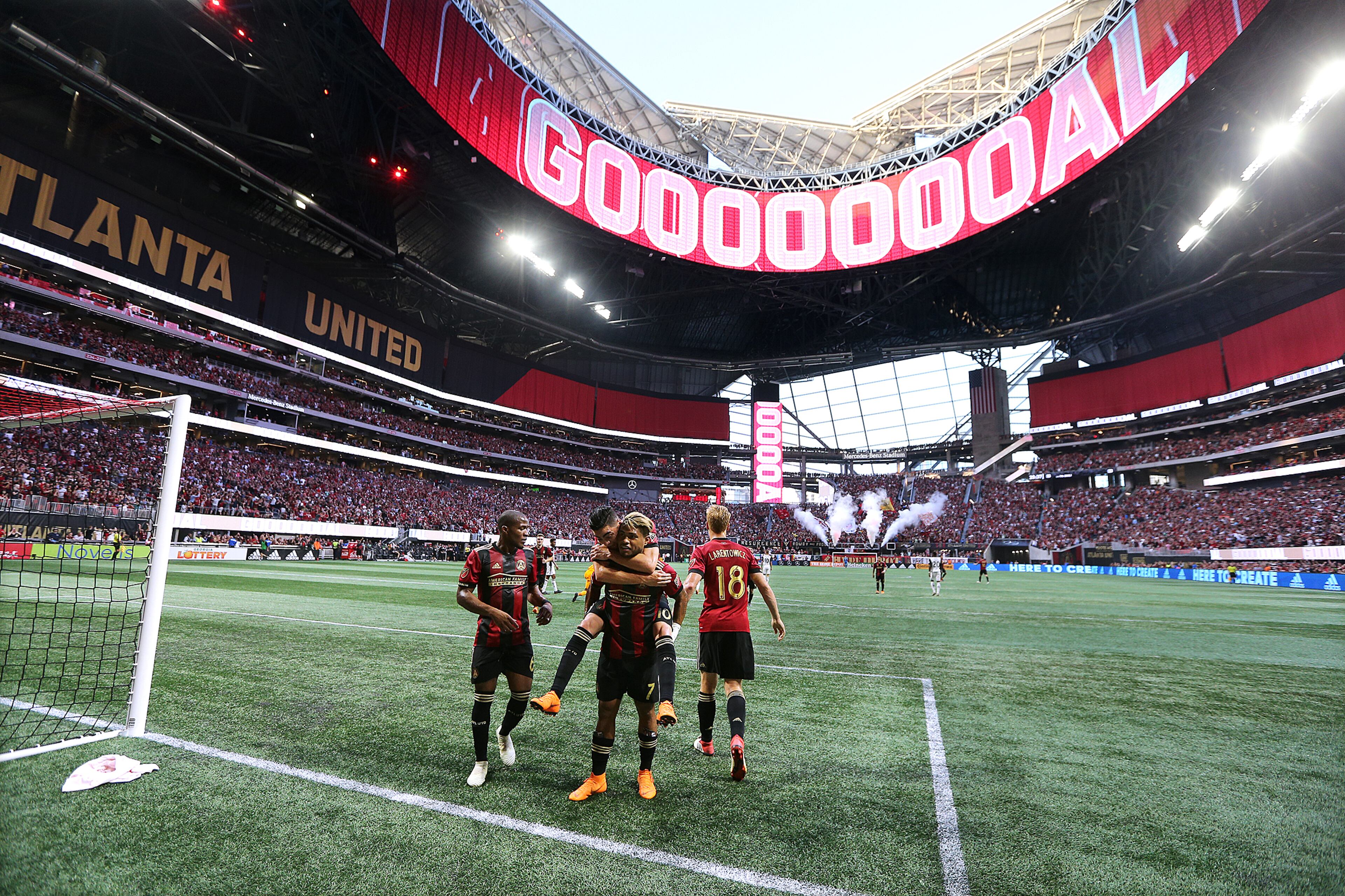 Miguel Almiron jumps on Josef Martinez’s back to celebrate Martinez’s goal for a 1-0 lead against Philadelphia Union Saturday, June 2, 2018, at Mercedes-Benz Stadium in Atlanta.