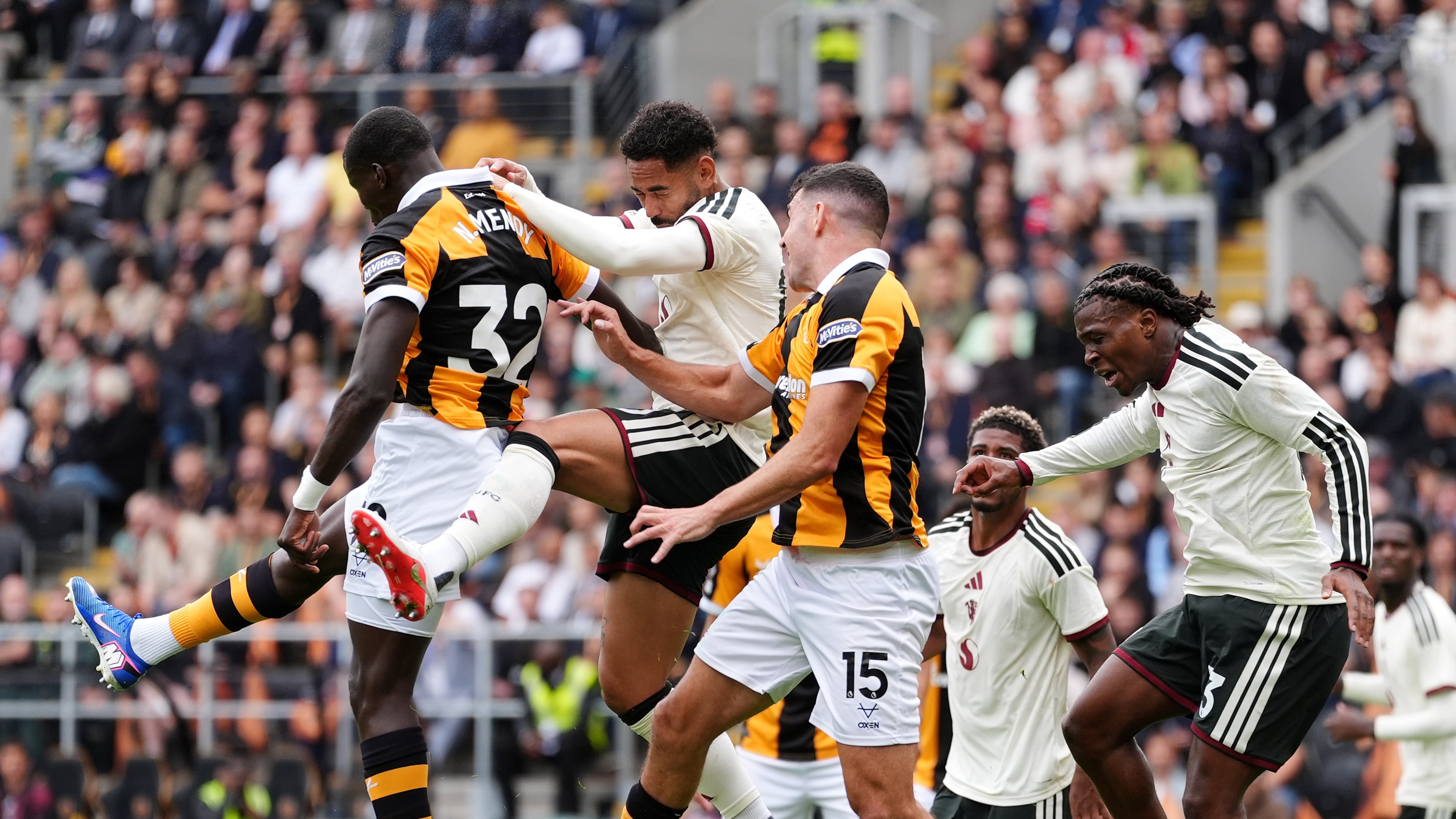 Manchester United's Matheus Cunha, second right, heads the ball during the English Premier League soccer match between Hull City and Manchester United in Kingston upon Hull, England, Saturday Aug. 22, 2026. (Annabel Lee-Ellis/PA via AP)