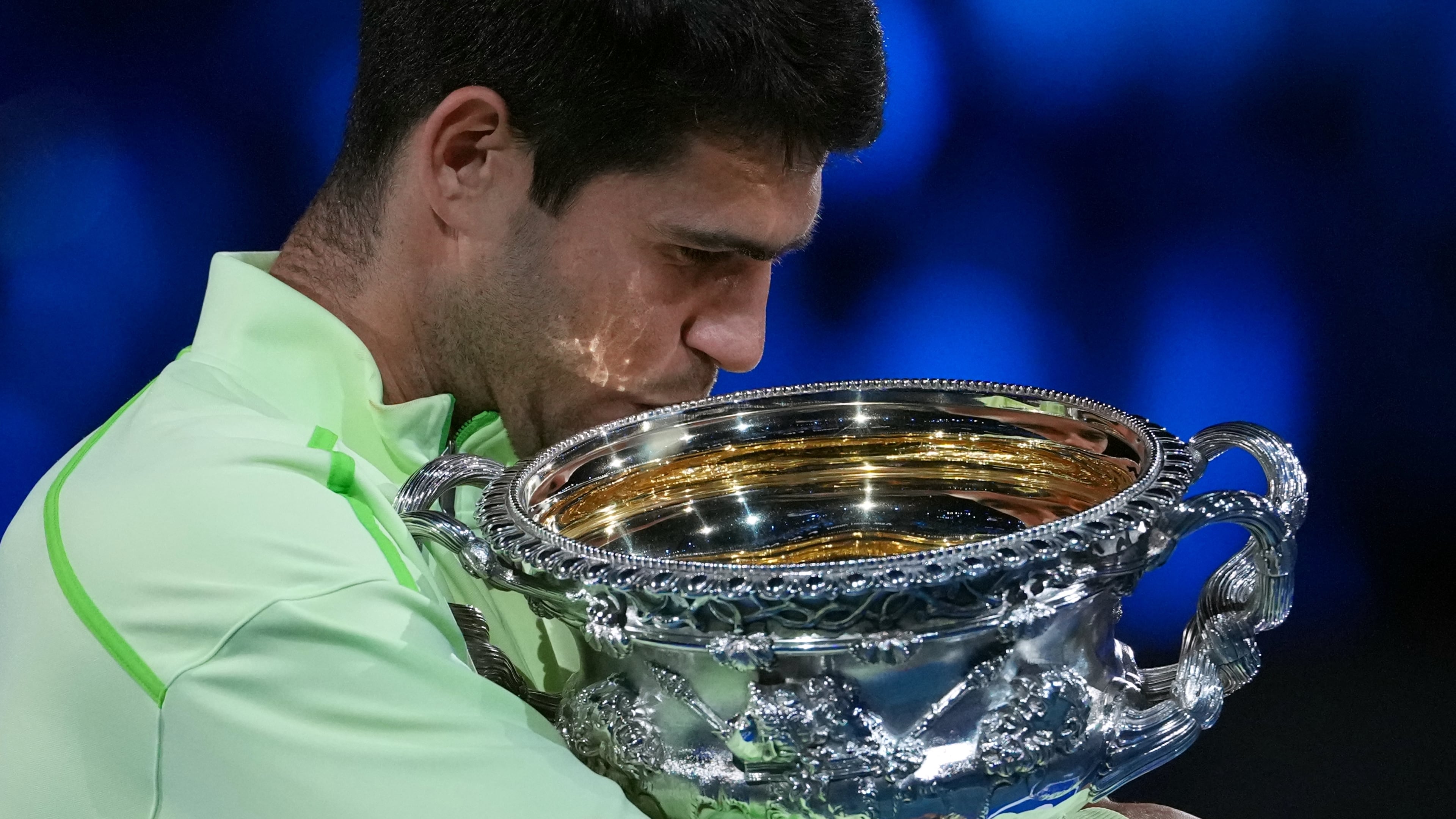 Carlos Alcaraz of Spain holds the Norman Brookes Challenge Cup after defeating Novak Djokovic of Serbia in the men's singles final at the Australian Open tennis championship in Melbourne, Australia, Sunday, Feb. 1, 2026. (AP Photo/Aaron Favila)