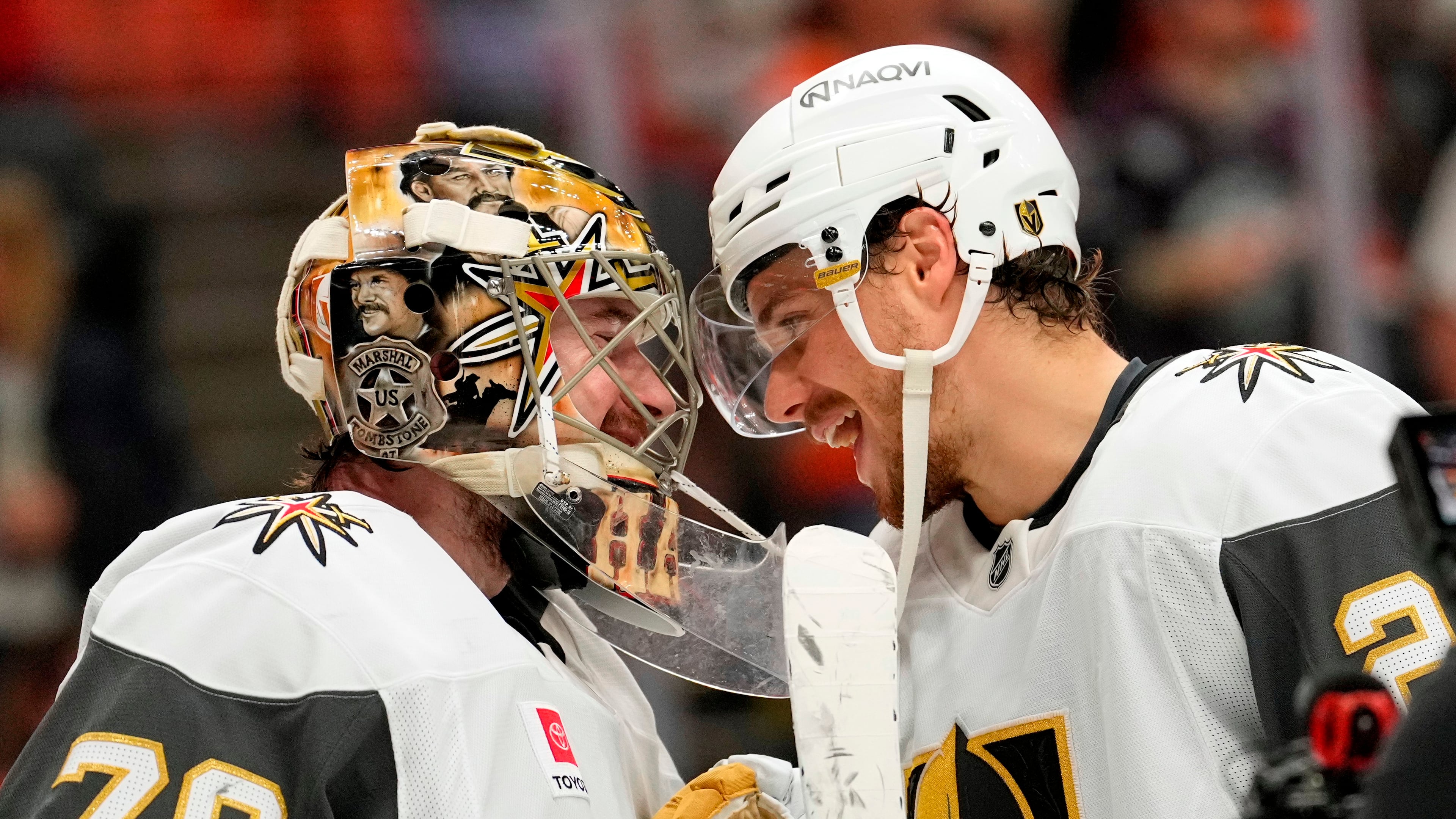 Vegas Golden Knights goaltender Carter Hart, left, and center Brett Howden congratulate each other after the Golden Knights defeated the Anaheim Ducks in Game 6 of a second-round NHL hockey Stanley Cup playoff series Thursday, May 14, 2026, in Anaheim, Calif. (AP Photo/Mark J. Terrill)
