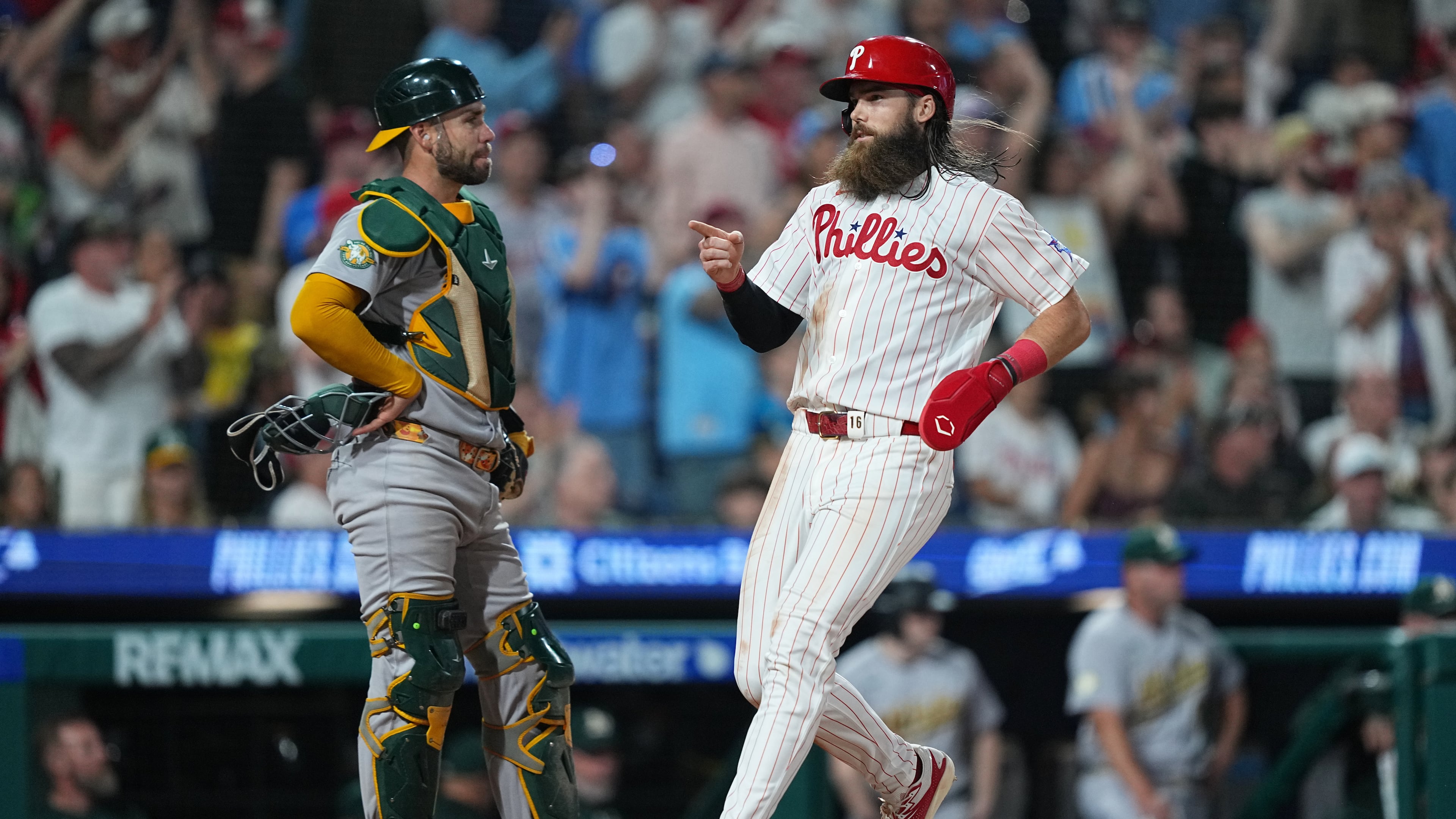 Philadelphia Phillies' Brandon Marsh scores past Athletics catcher Austin Wynns during the seventh inning of a baseball game, Tuesday, May 5, 2026, in Philadelphia. (AP Photo/Matt Rourke)