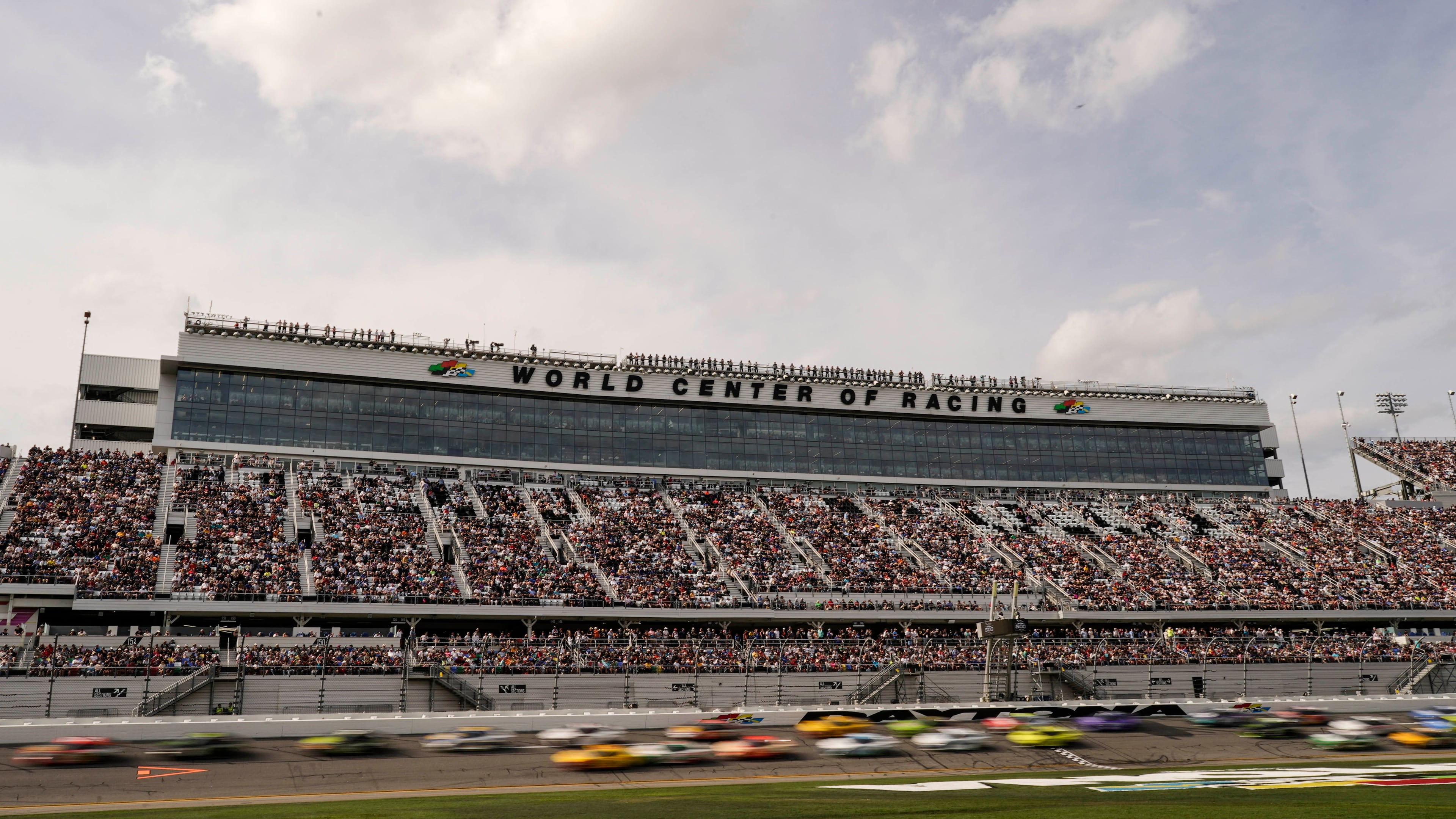FILE - Cars move during the NASCAR Daytona 500 auto race at Daytona International Speedway, Feb. 15, 2026, in Daytona Beach, Fla. (AP Photo/Nigel Cook, File)