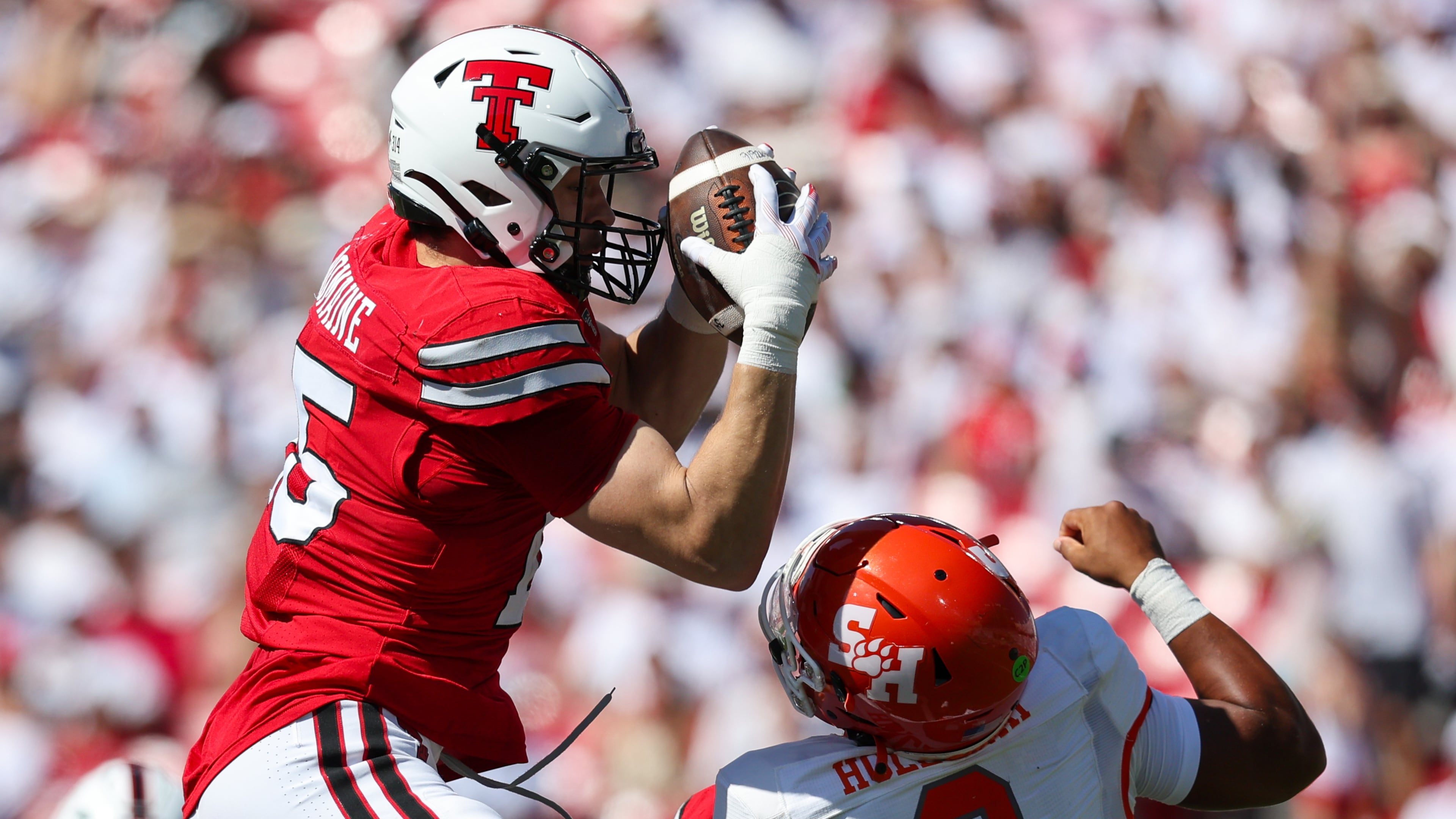 Texas Tech linebacker Austin Romaine (15) intercepts pass over Sam Houston State's Brett Holloway during the first half of an NCAA college football game, Saturday, Sept. 26, 2026, in Lubbock, Texas. (AP Photo/Chase Seabolt)