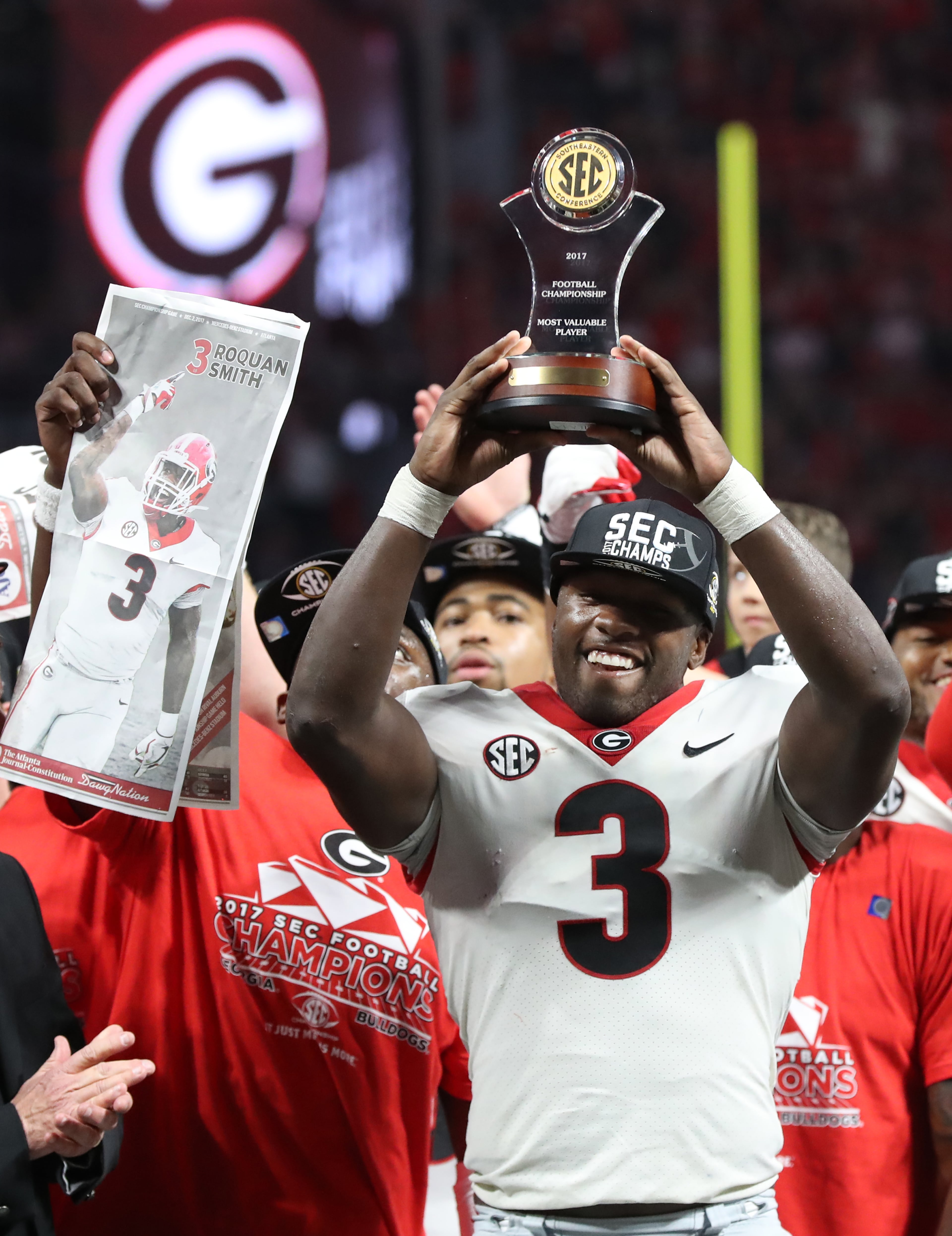 December 2, 2017 Atlanta: Roquan Smith hoists his MVP trophy after beating Auburn in the SEC Football Championship at Mercedes-Benz Stadium, December 2, 2017, in Atlanta. Georgia won 28-7. Curtis Compton / ccompton@ajc.com