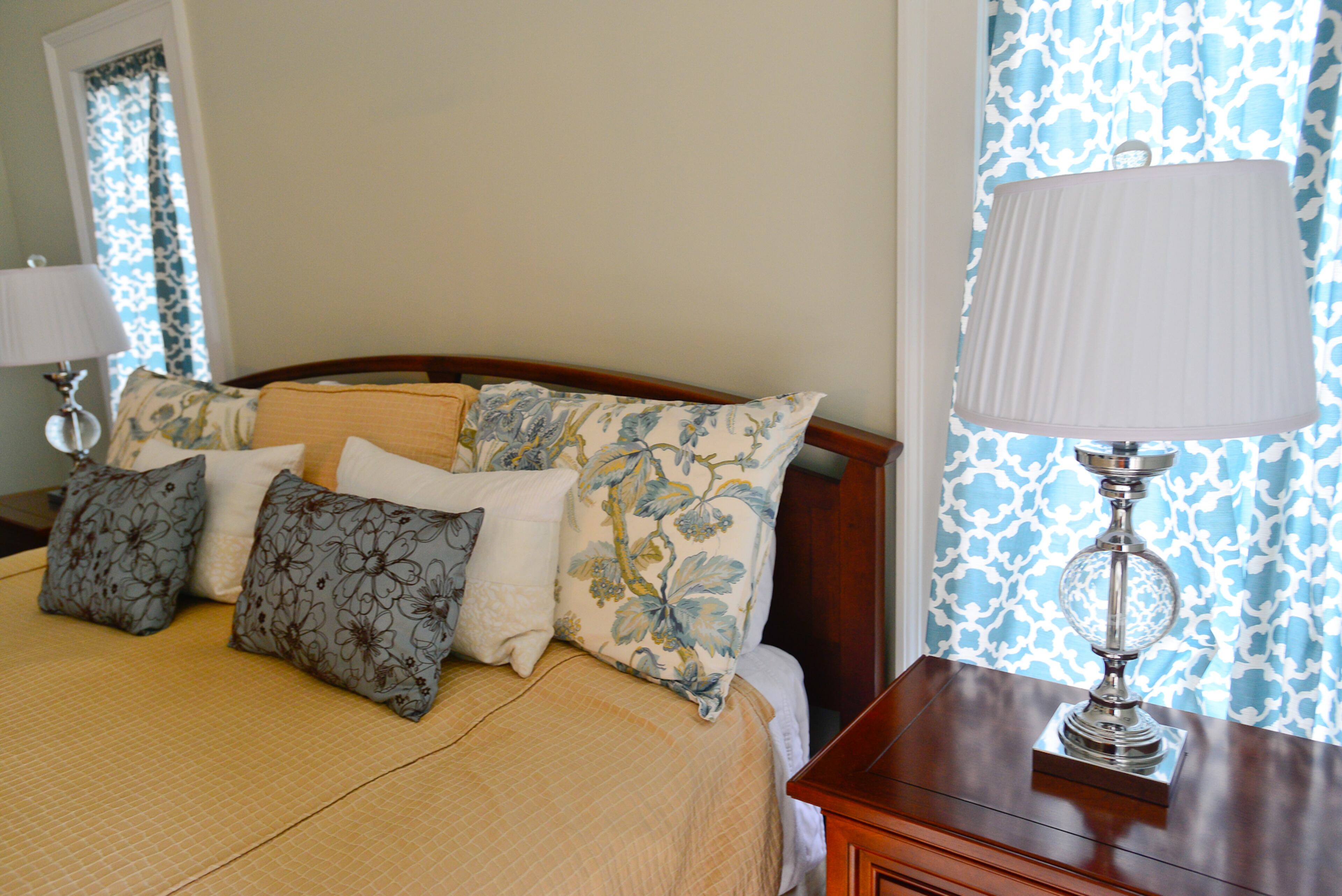 A headboard from Ethan Allen, lamps from HomeGoods and bedding from Pottery Barn highlight the master bedroom.