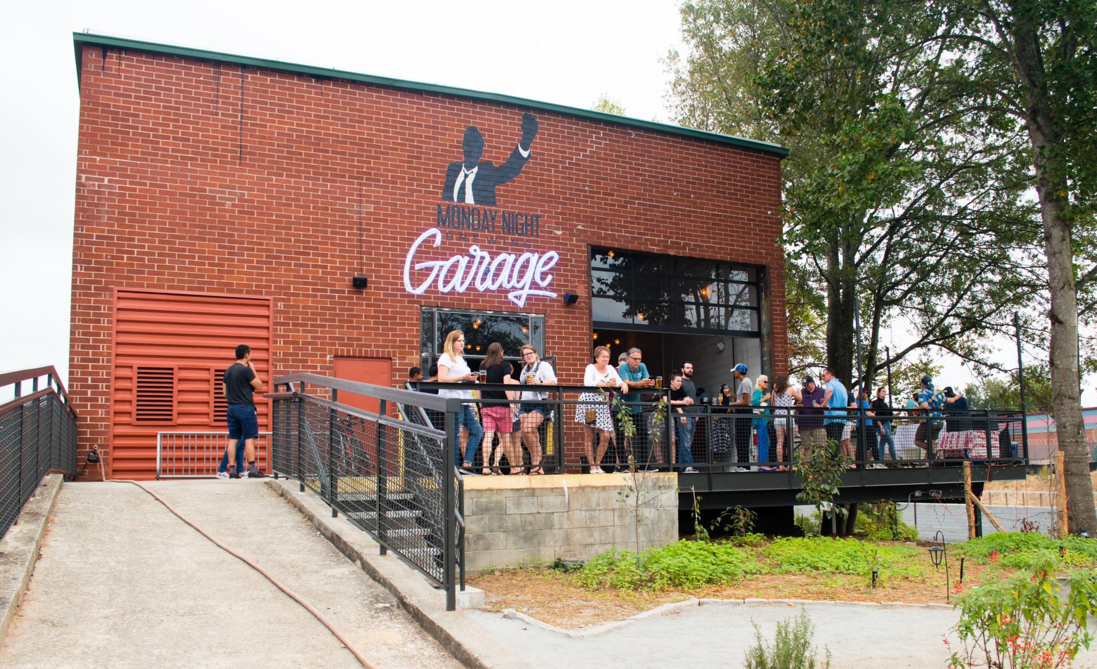 The new Monday Night Garage is huge and built for socializing, with a large wrap-around deck, fire pits outside and a massive, warehouse-like interior. CONTRIBUTED BY HENRI HOLLIS