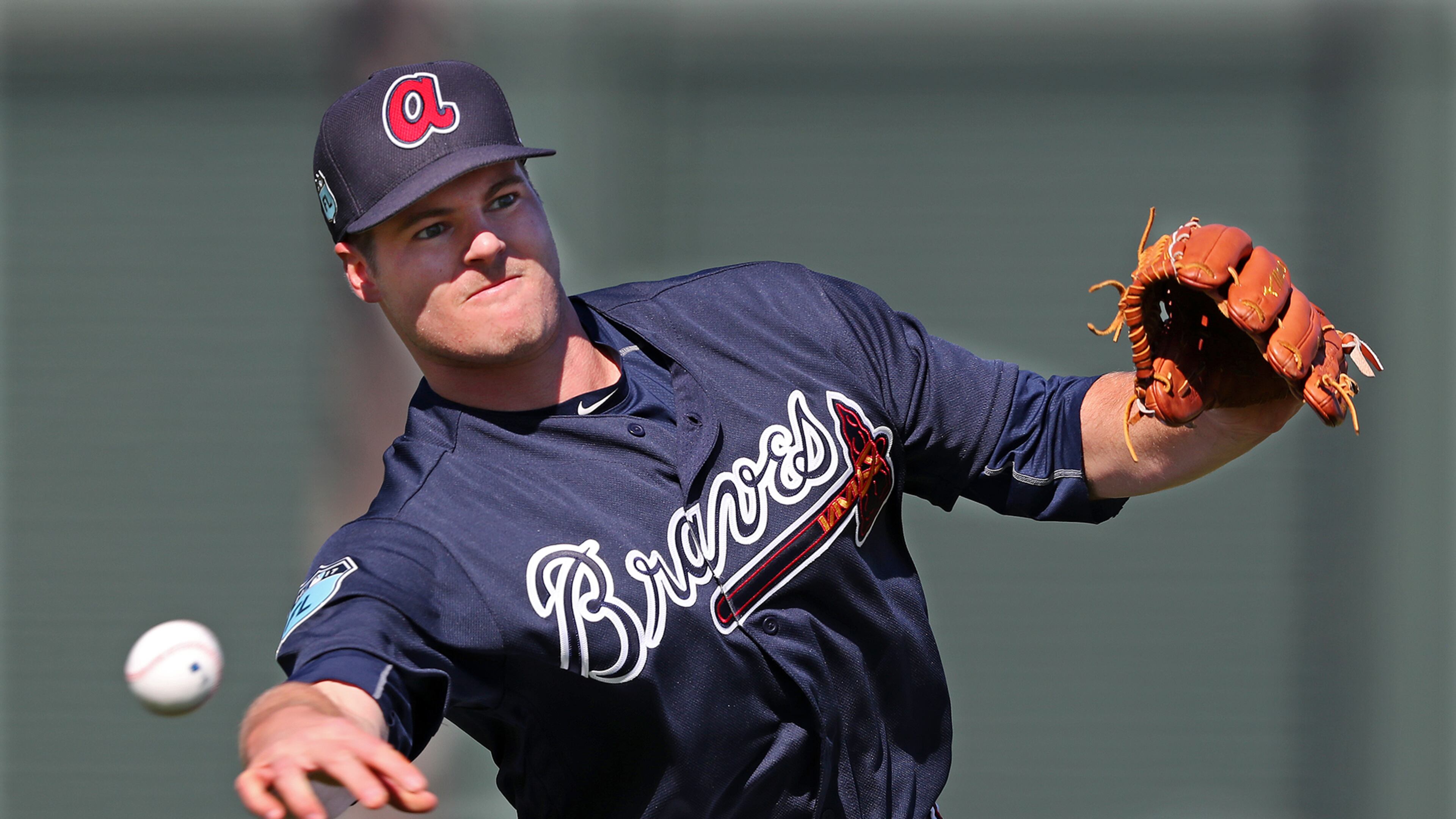 Braves pitcher Jason Hursh throws to first after fielding a grounder during spring training at the ESPN Wide World of Sports in Lake Buena Vista. Curtis Compton/ccompton@ajc.com
