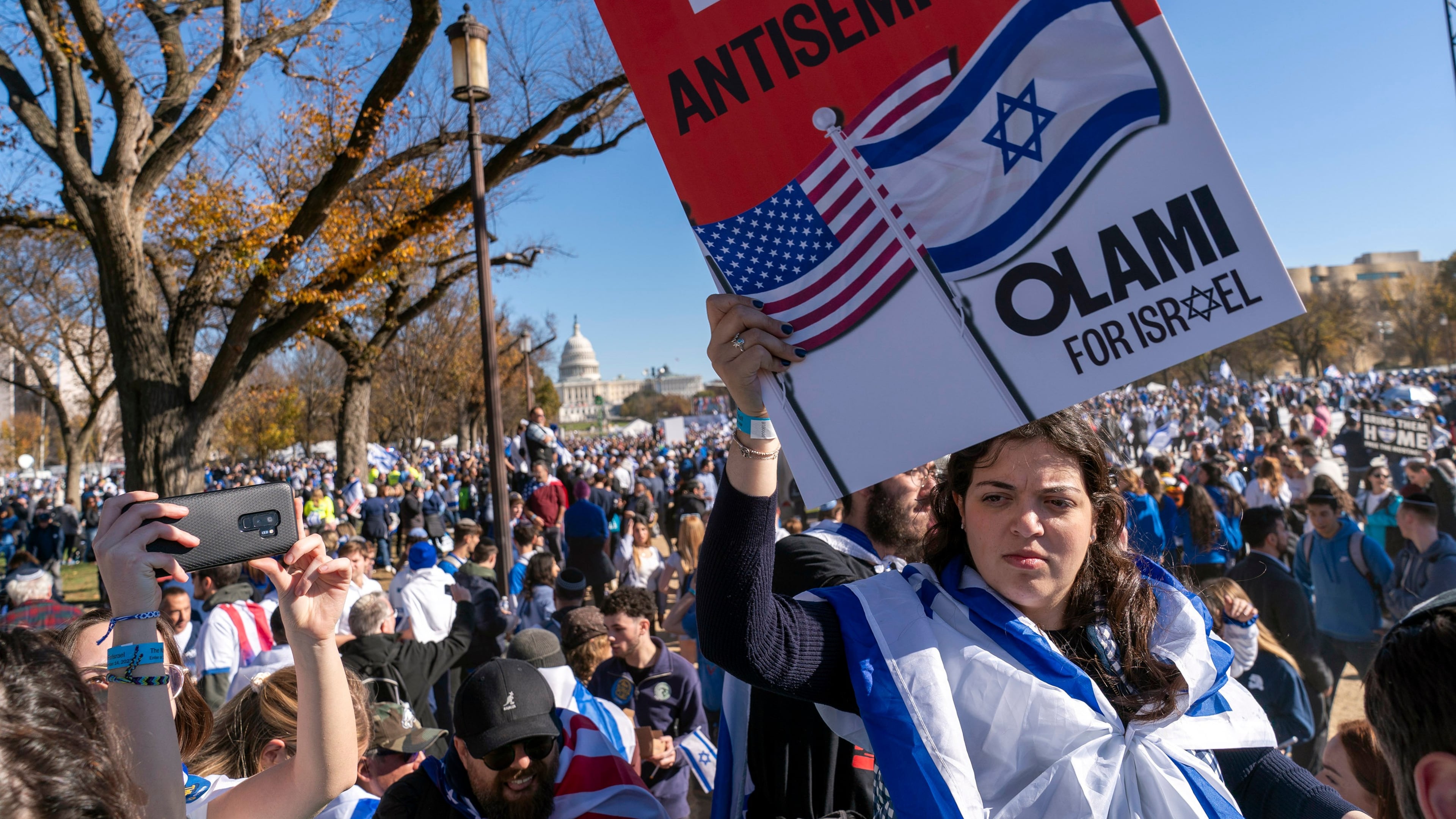 FILE - A woman holds a sign saying, "end antisemitism" while attending a March for Israel rally Nov. 14, 2023, on the National Mall in Washington. (AP Photo/Jacquelyn Martin, File)