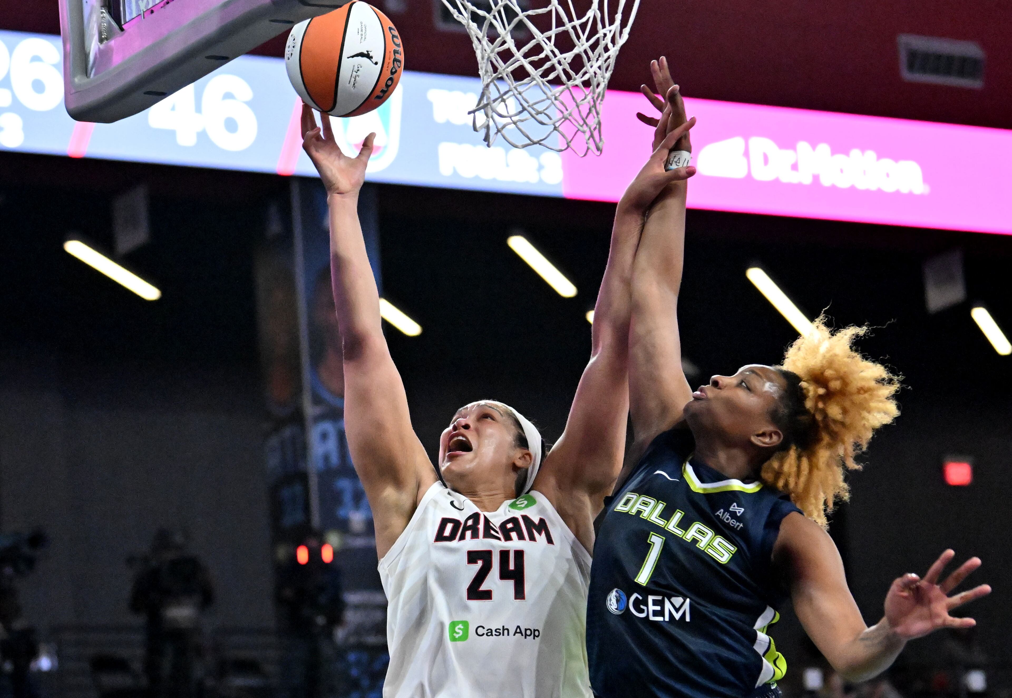 Atlanta Dream forward Brionna Jones (24) goes to the basket for the shot against Dallas Wings forward NaLyssa Smith (1) during the second half in a WNBA basketball game at Gateway Center Arena, Saturday, May 24, 2025, in Atlanta. Atlanta Dream won 83-75 over Dallas Wings. (Hyosub Shin / AJC)