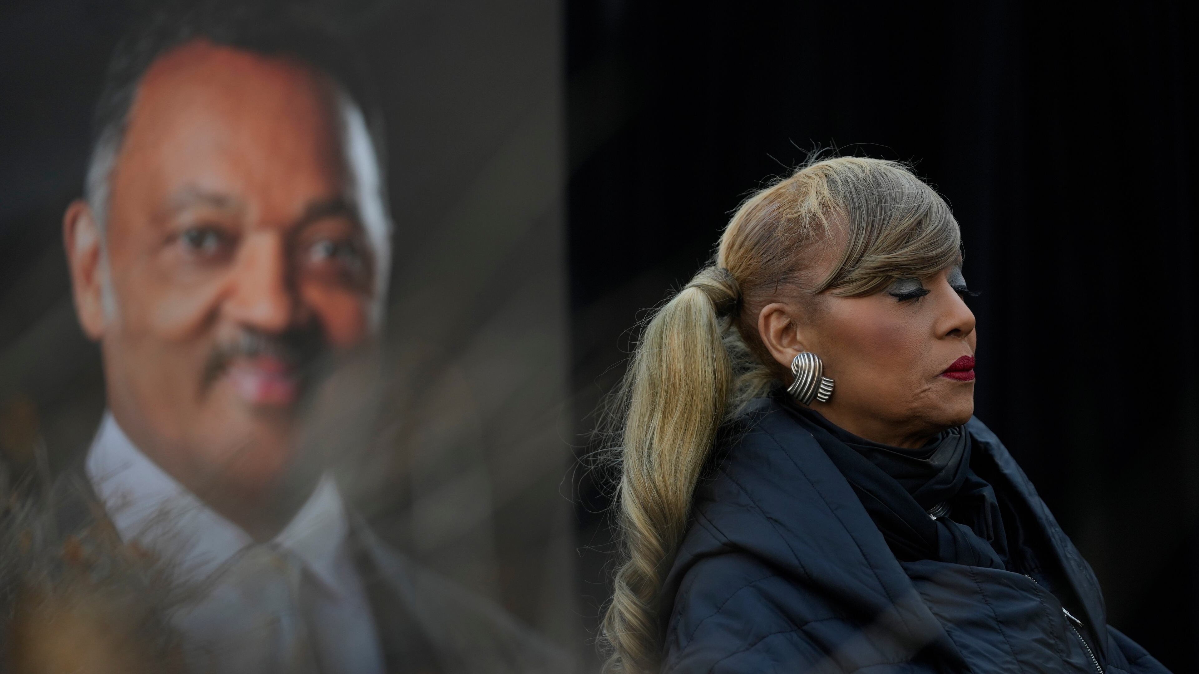 Santita Jackson stands near a picture of her father, the Rev. Jesse Jackson, during a news conference outside the family home Wednesday, Feb. 18, 2026, in Chicago. (AP Photo/Erin Hooley)