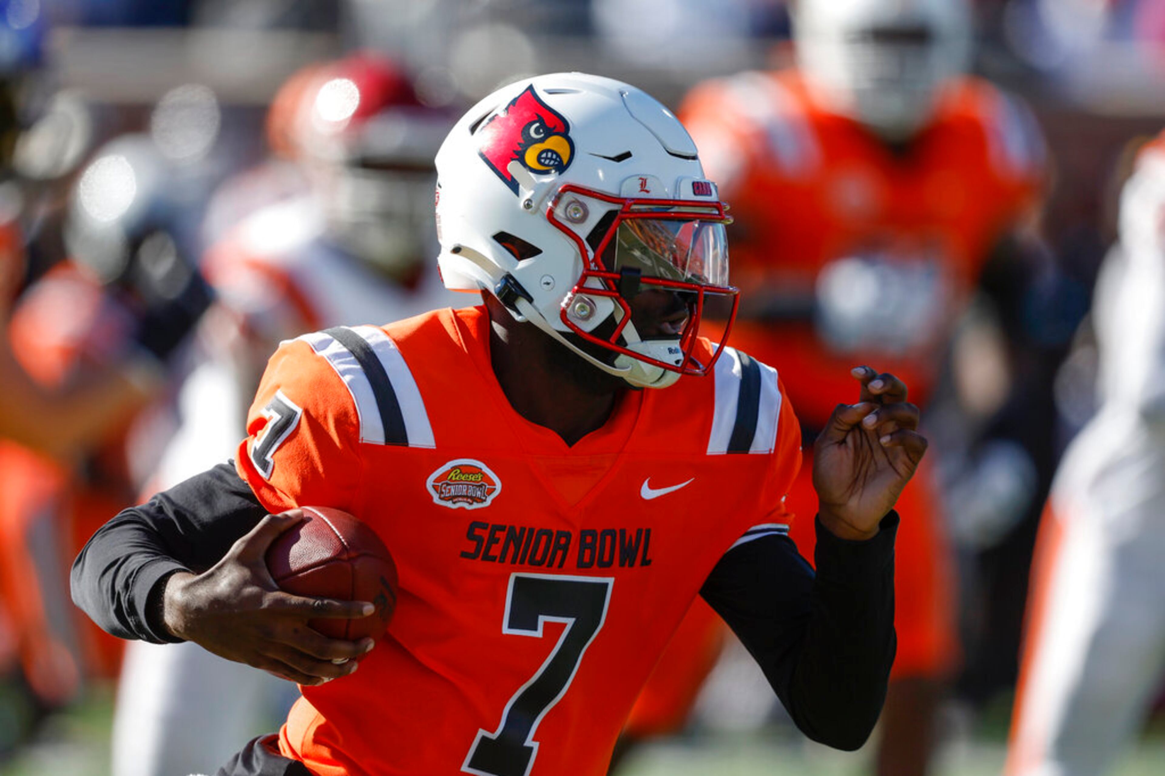 National quarterback Malik Cunningham, of Louisville, carries the ball during the first half of the Senior Bowl NCAA college football game, Saturday, Feb. 4, 2023, in Mobile, Ala.. (AP Photo/Butch Dill)