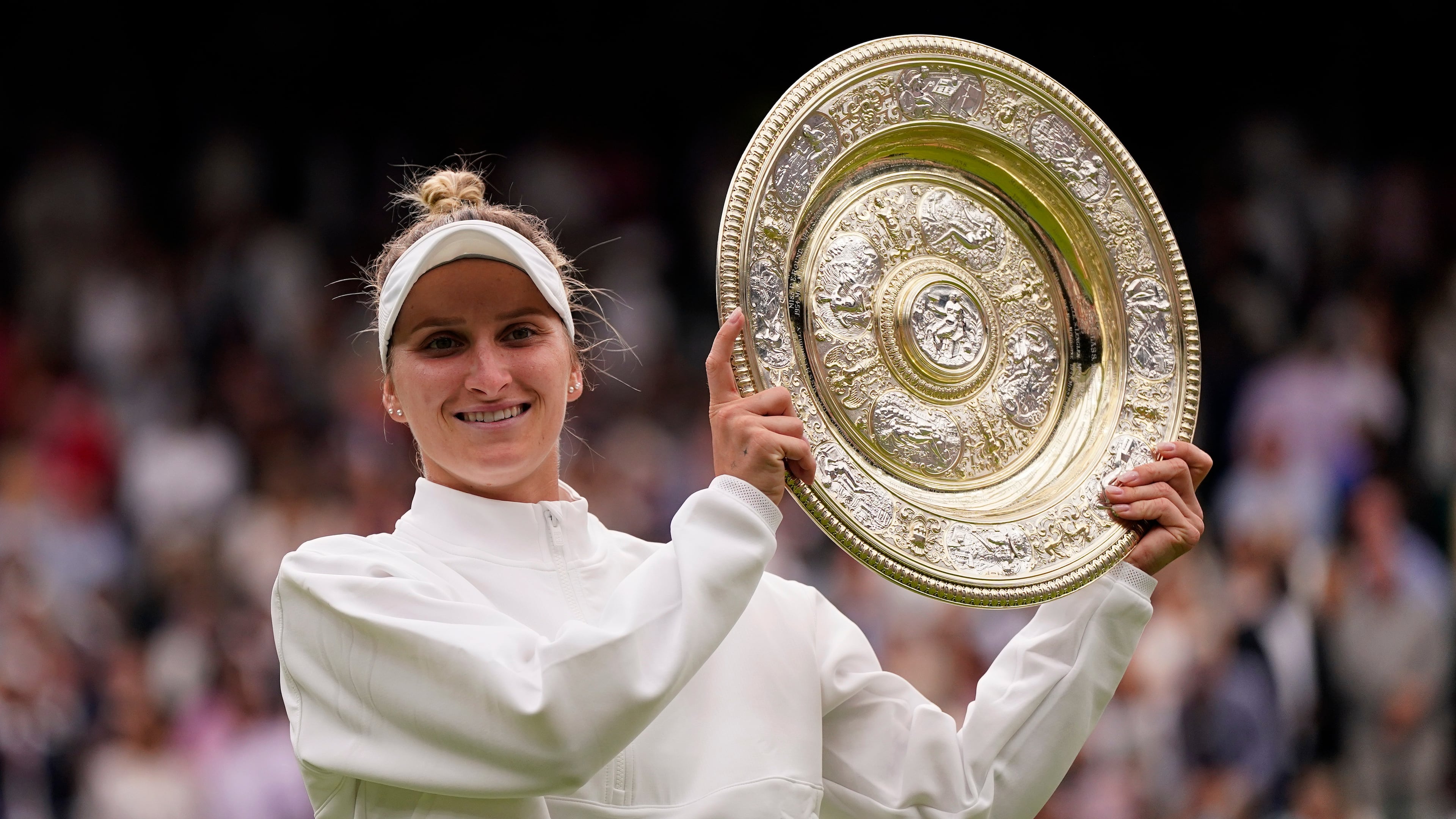 FILE - Czech Republic's Marketa Vondrousova celebrates with the trophy after beating Tunisia's Ons Jabeur to win the final of the women's singles on day thirteen of the Wimbledon tennis championships in London, Saturday, July 15, 2023. (AP Photo/Alberto Pezzali, file)