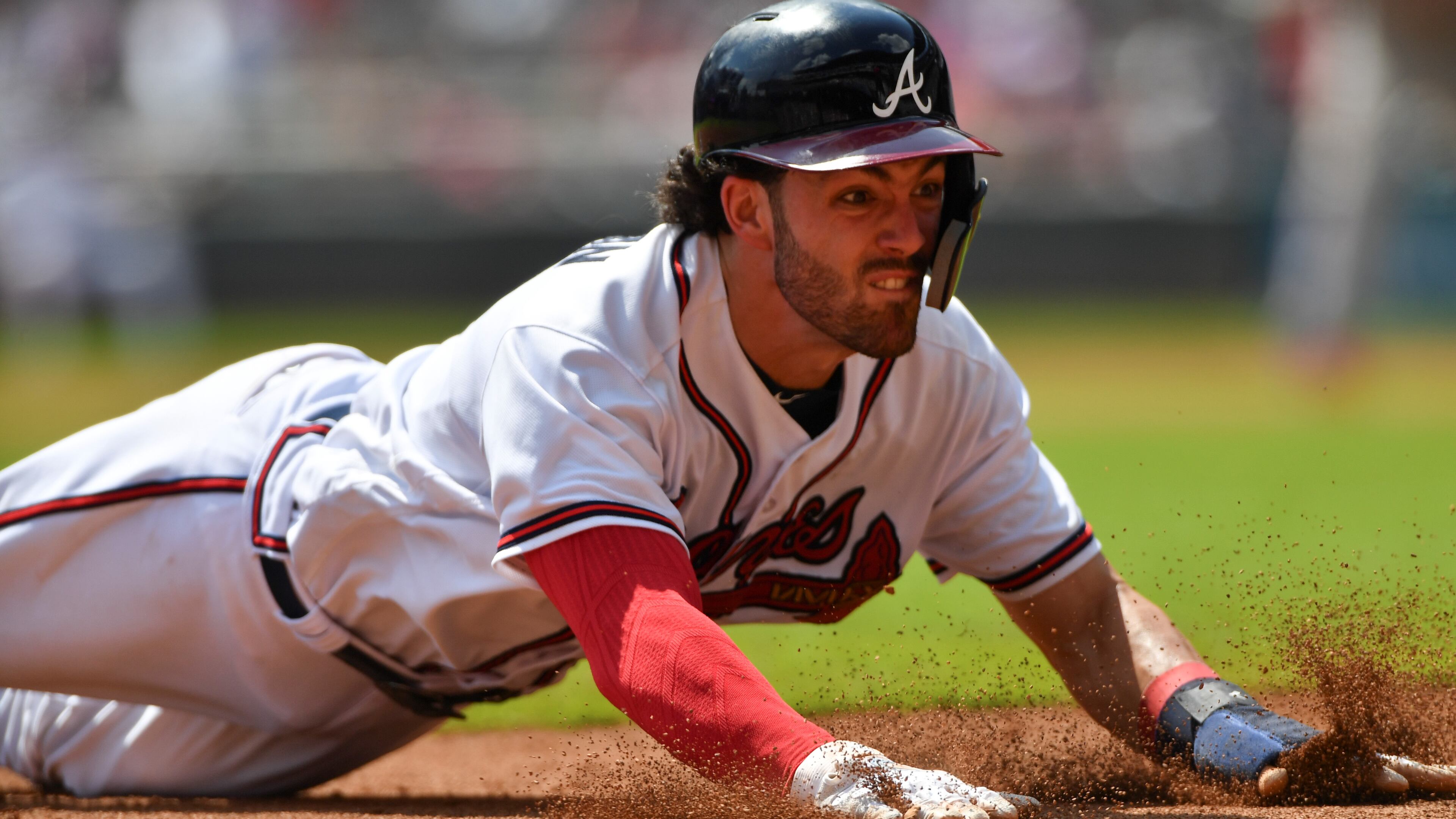 Atlanta Braves Dansby Swanson dives into third, but not before the tag of Philadelphia Phillies third baseman Maikel Franco at SunTrust Park Saturday September 22, 2018. Photo by Brant Sanderlin/AJC