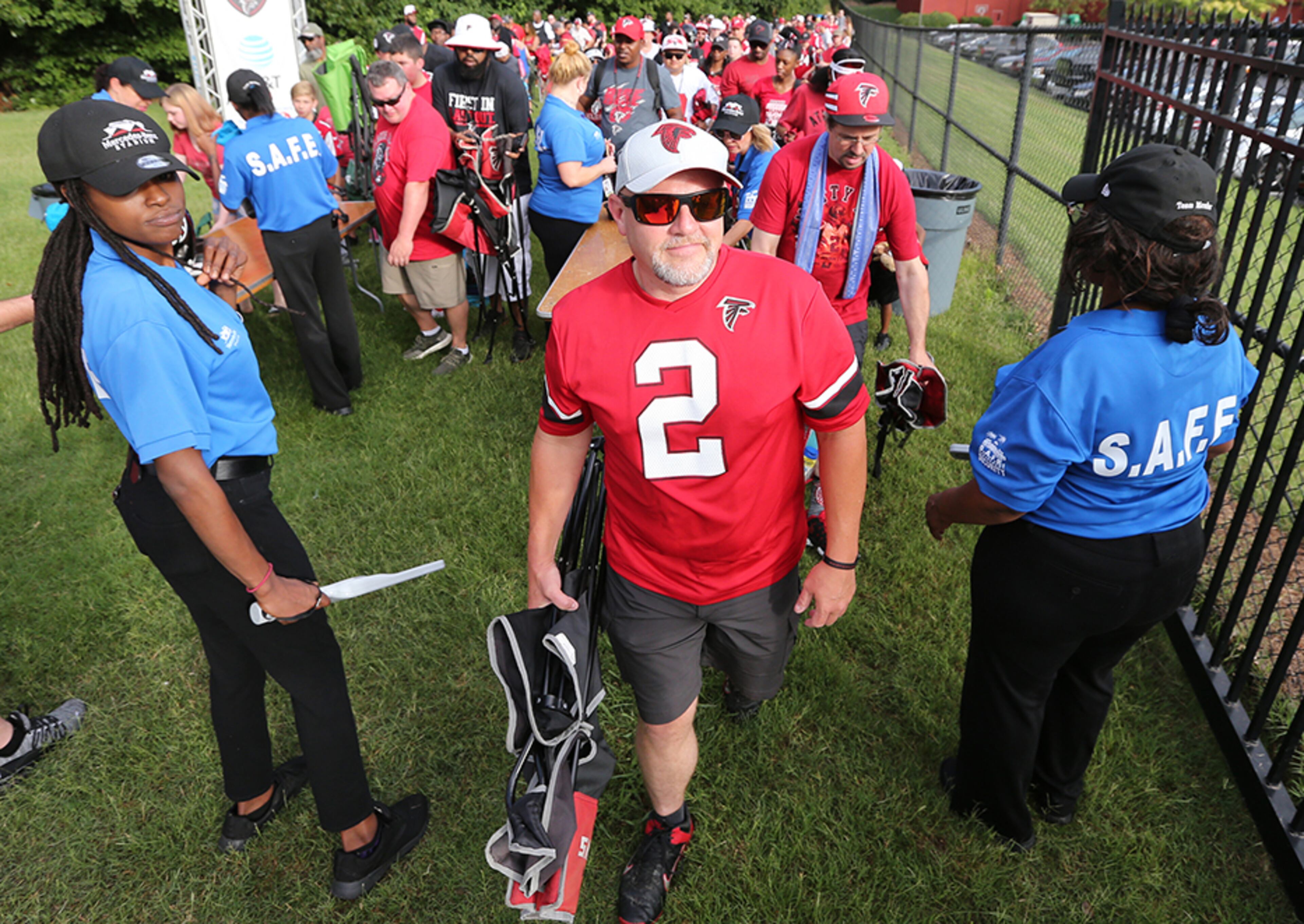 Falcons fan John Bennett, of Gainesville, is the first to enter the team's training facility for the first practice of training camp Monday, July 22, 2019, in Flowery Branch.
