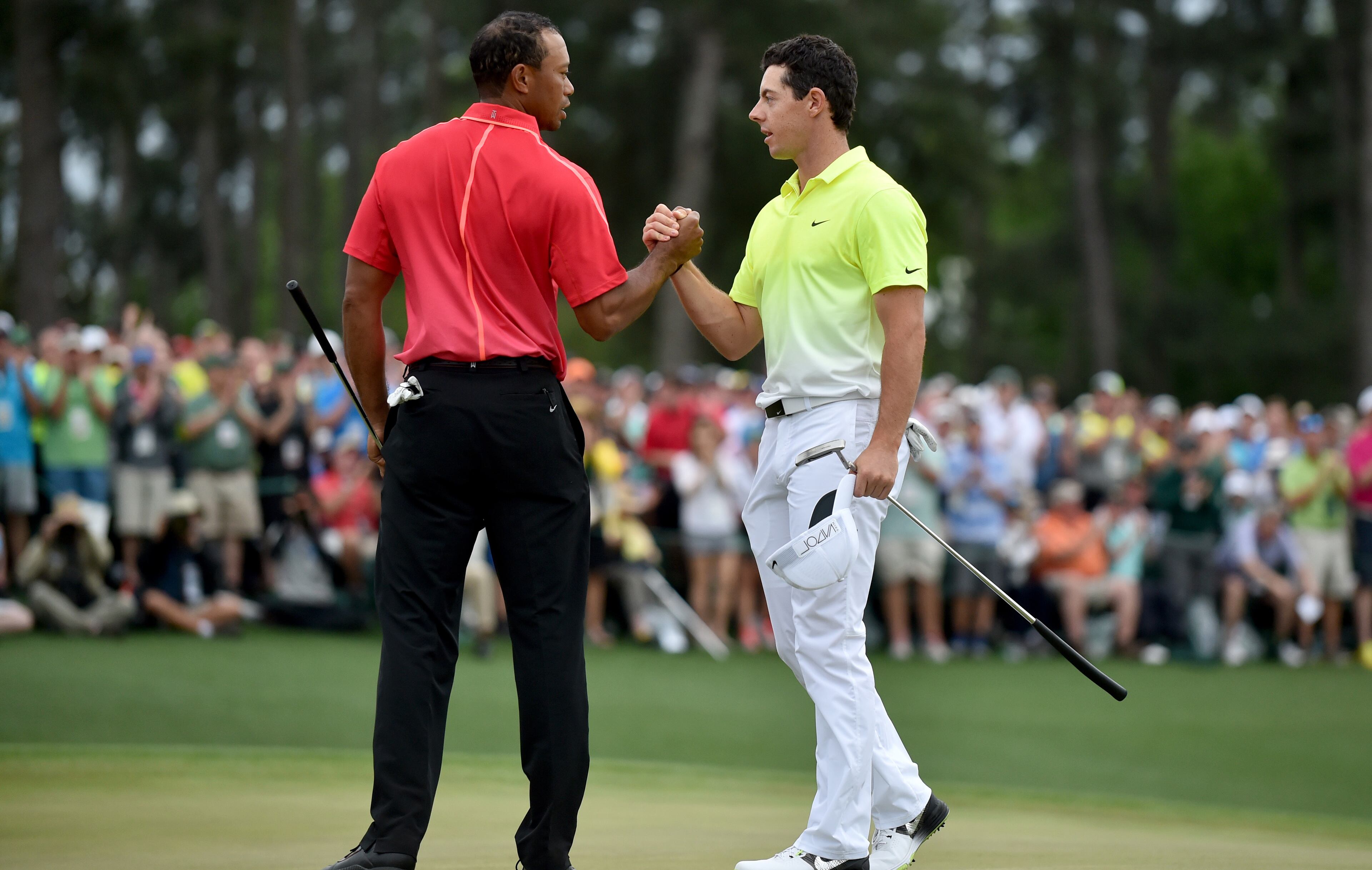 Tiger Woods, left, and Rory McIlroy on the 18th hole following the 2015 Masters at Augusta National Sunday April 12, 2015. Woods finished tied for 17th. McIlory finished 4th. BRANT SANDERLIN/BSANDERLIN@AJC.COM