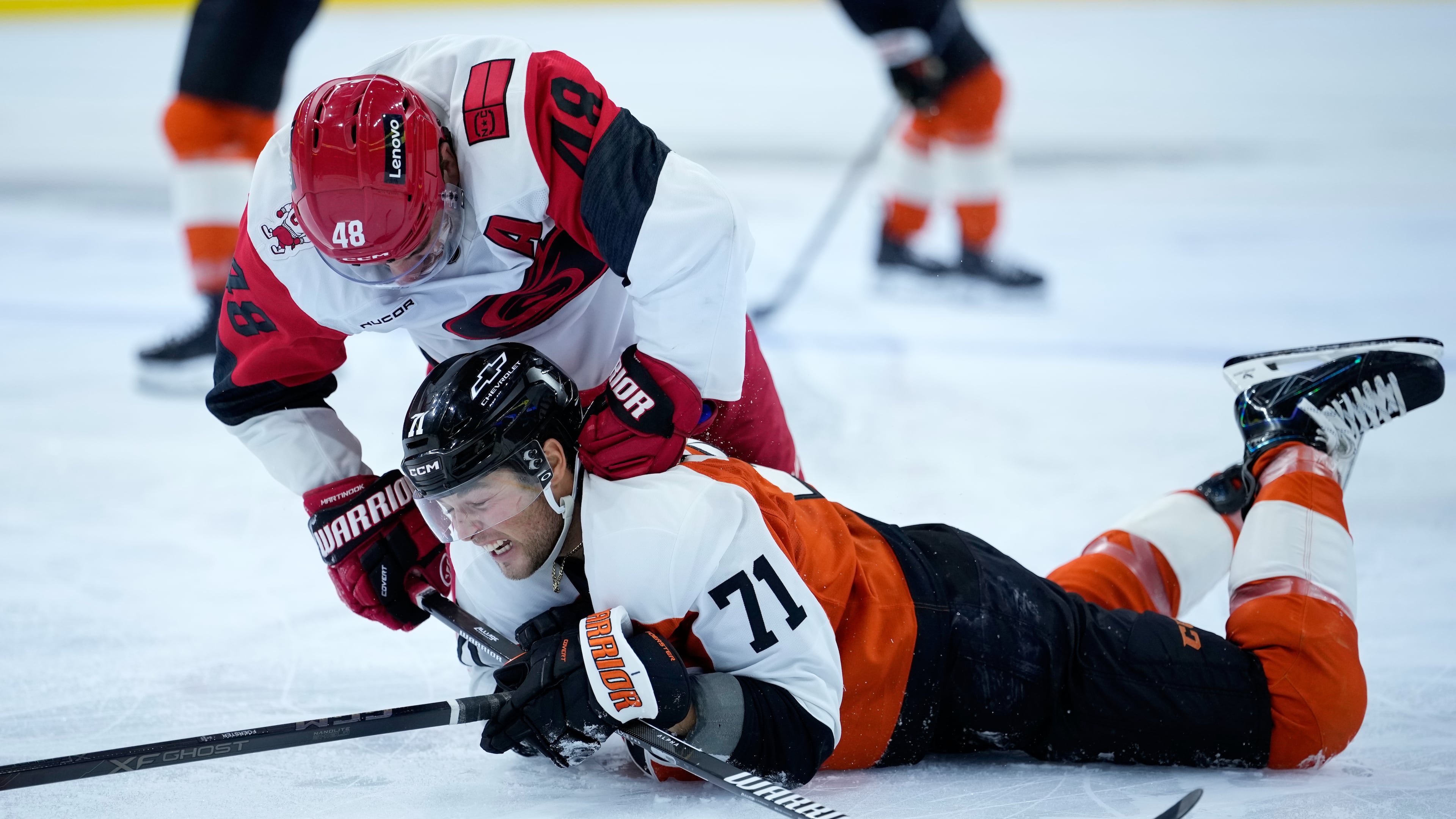 Carolina Hurricanes' Jordan Martinook, left, punches Philadelphia Flyers' Tyson Foerster during the second period of an NHL hockey game Sunday, Oct. 11, 2026, in Philadelphia. (AP Photo/Matt Slocum)