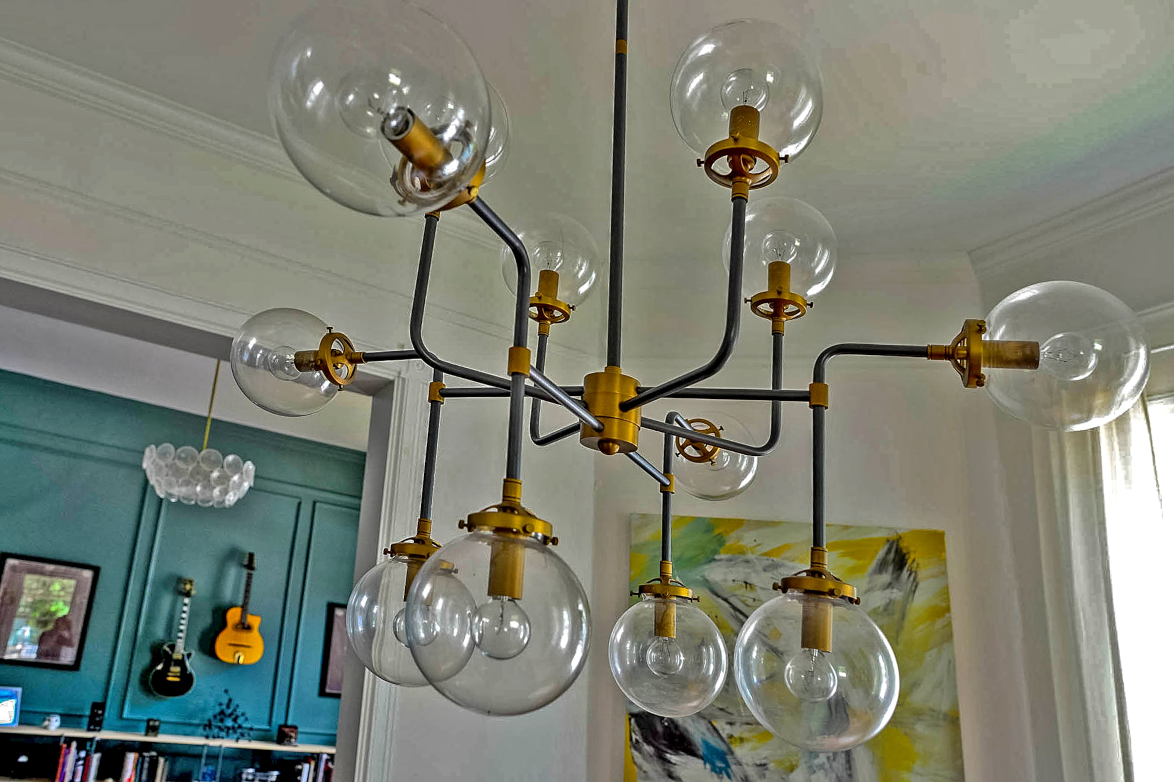 A globe chandelier from RH adds an industrial touch to the renovated main level of the Victorian home in Grant Park.