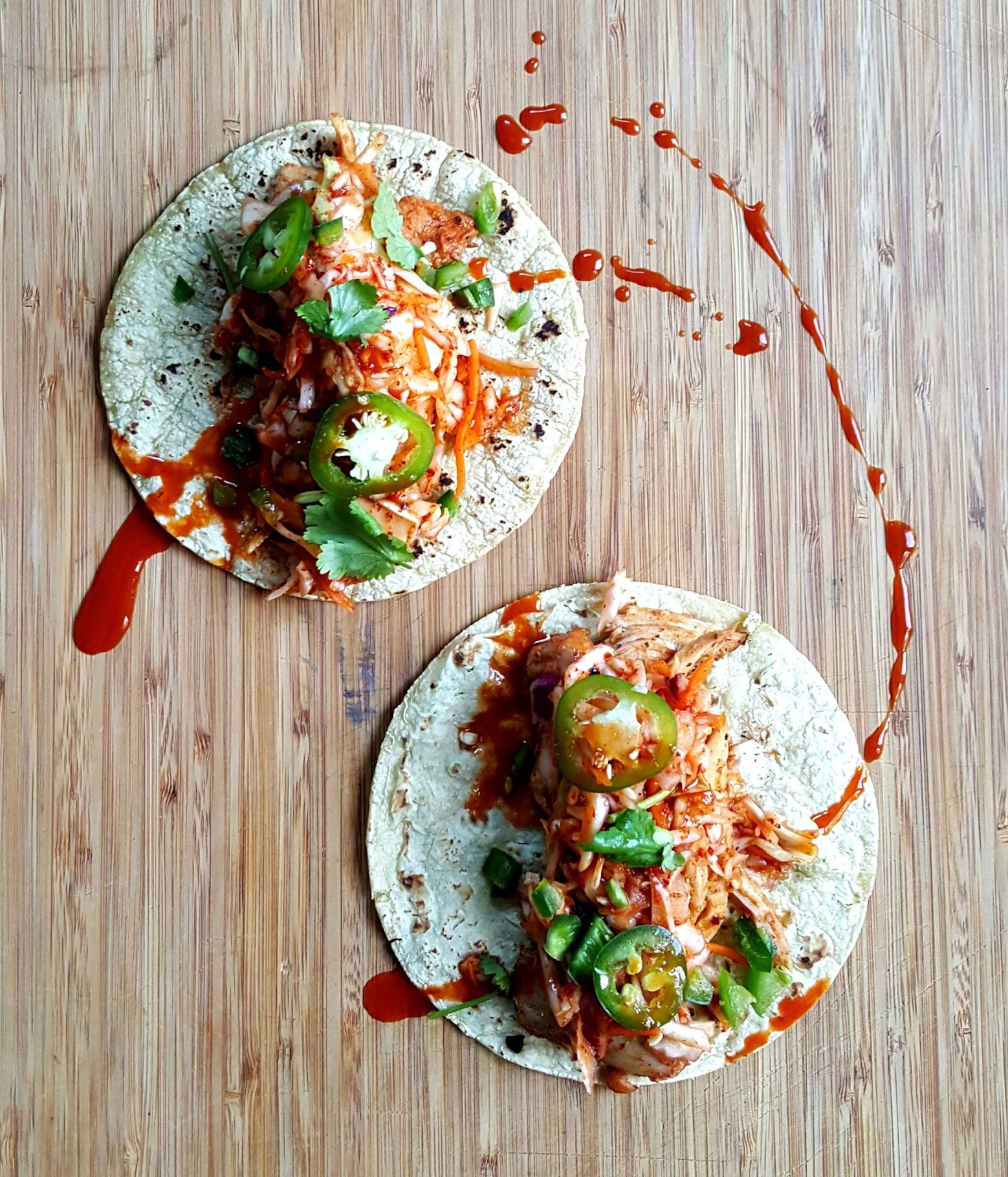 Heirloom Market BBQ’s tacos are made with smoked, gochujang-marinated pork and dressed with kimchi slaw, jalapeño, cilantro and spicy Korean barbecue sauce. CONTRIBUTED BY HEIRLOOM MARKET BBQ