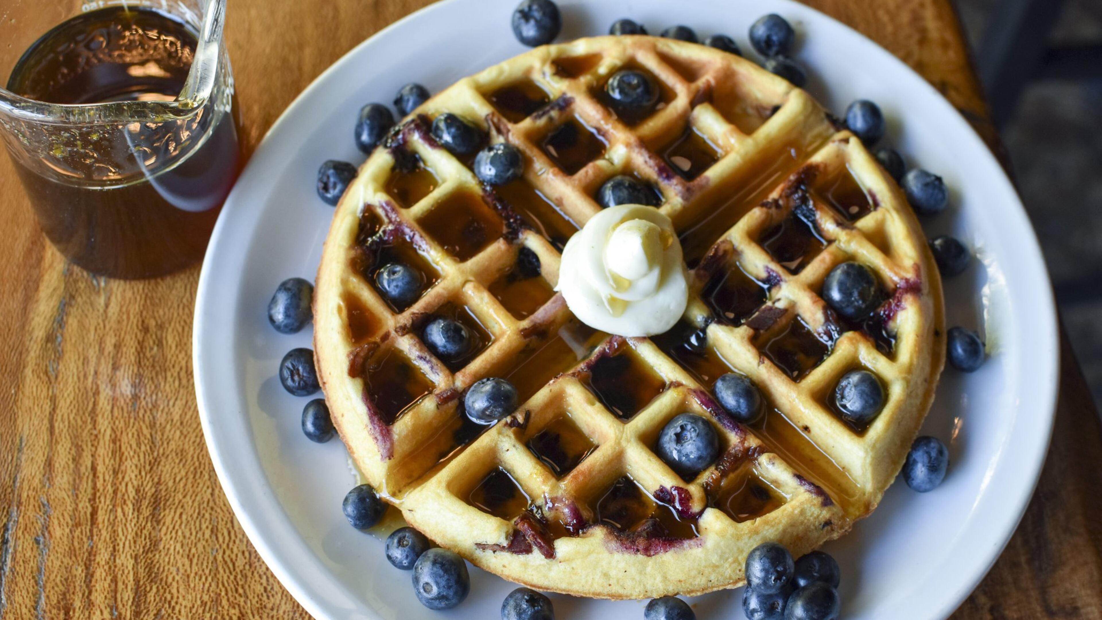 Chef Ryan Burke of Twain’s Brewpub and Billiards in Decatur makes Blueberry-Bacon Waffles with with Orange-Maple Syrup for his family. CONTRIBUTED BY HENRI HOLLIS