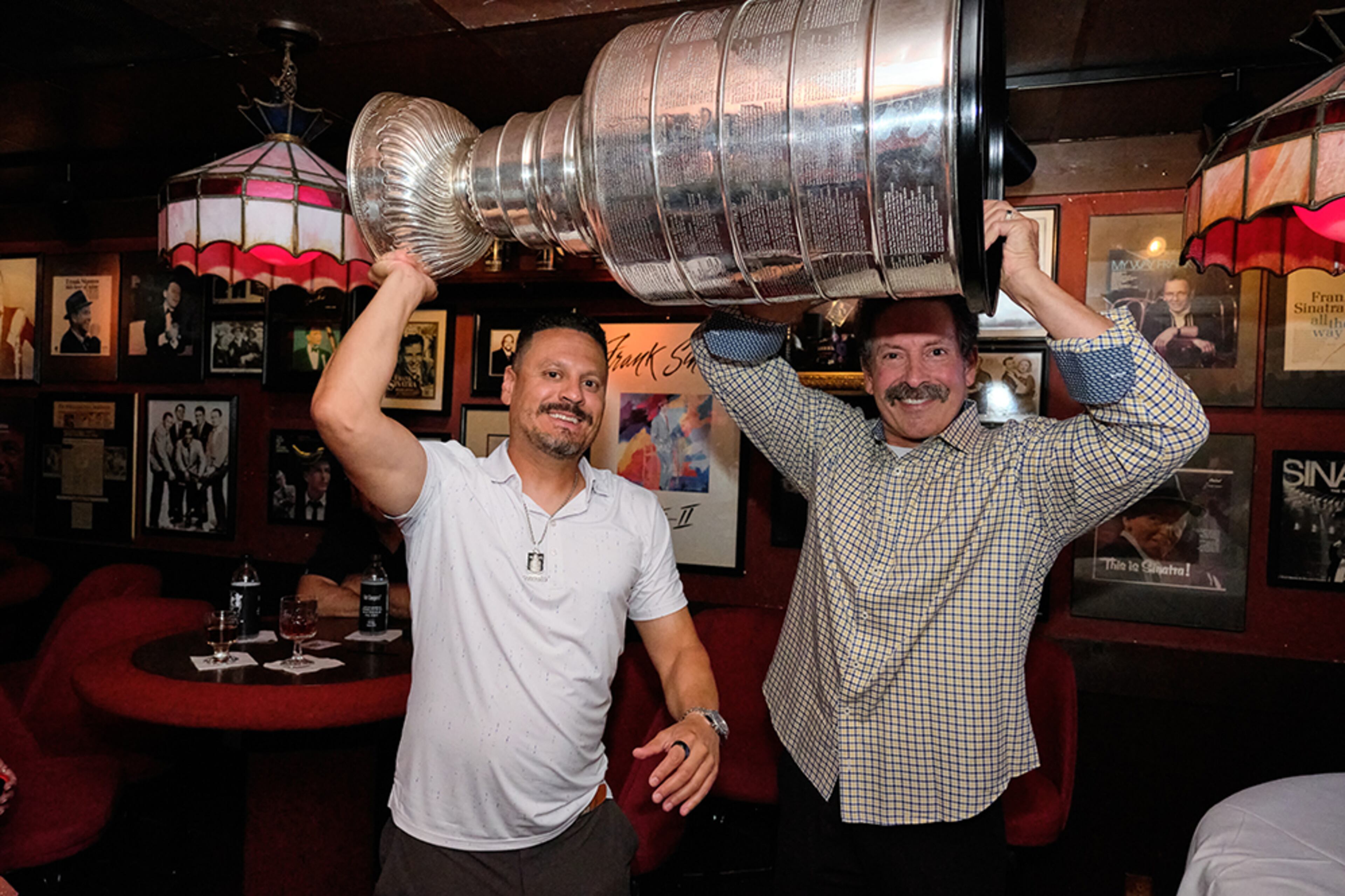 Mike Huff (left) with Chris D'Auria, the owner of Johnny's Hideaway. The Stanley Cup made an appearance at Johnny's Hideaway on Tuesday, July 15. (Credit: Brandon Amato, courtesy of Johnny's Hideaway)