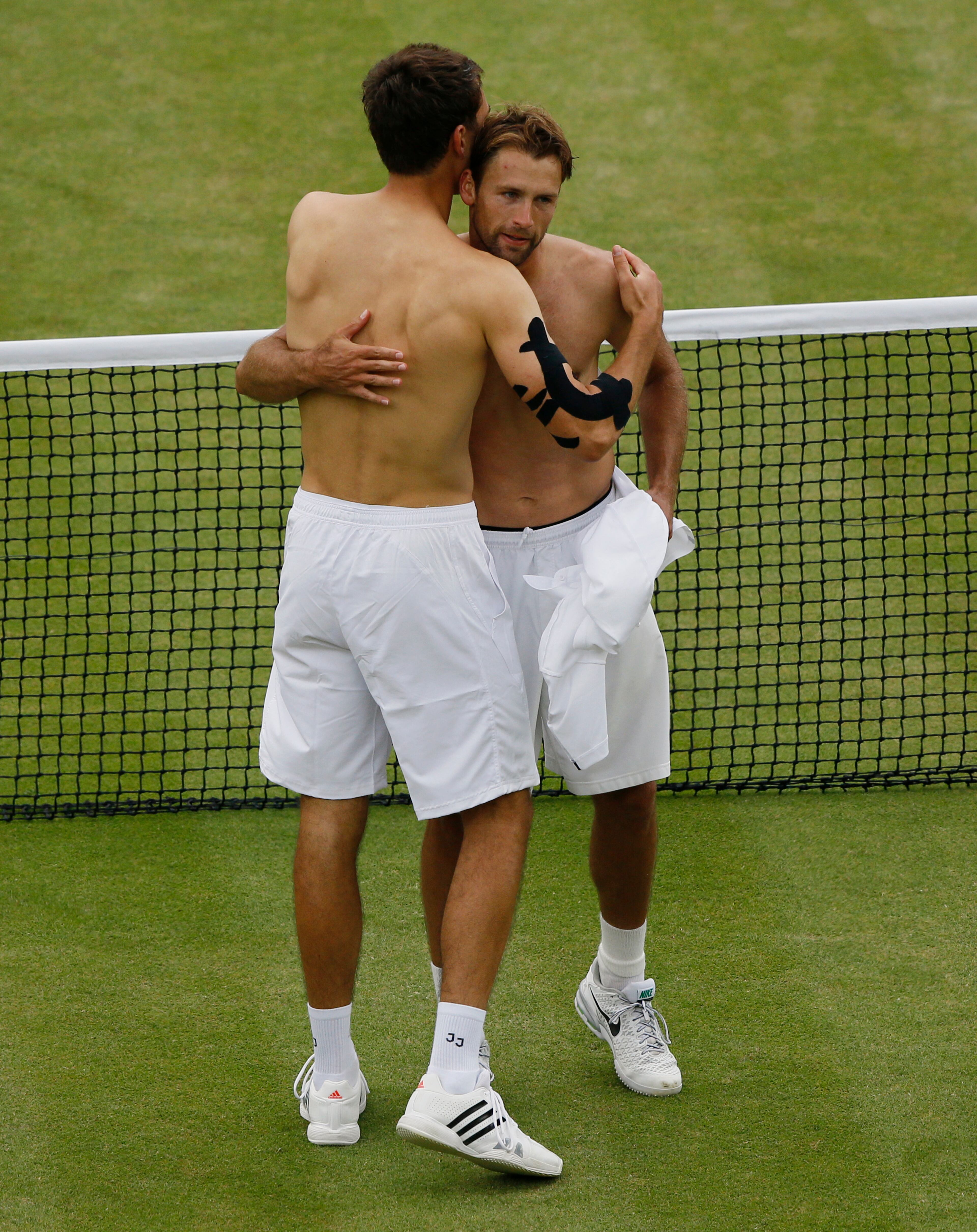 Jerzy Janowicz of Poland, left, embraces Lukasz Kubot of Poland after winning their Men's singles quarterfinal match at the All England Lawn Tennis Championships in Wimbledon, London, Wednesday, July 3, 2013. (AP Photo/Kirsty Wigglesworth)
