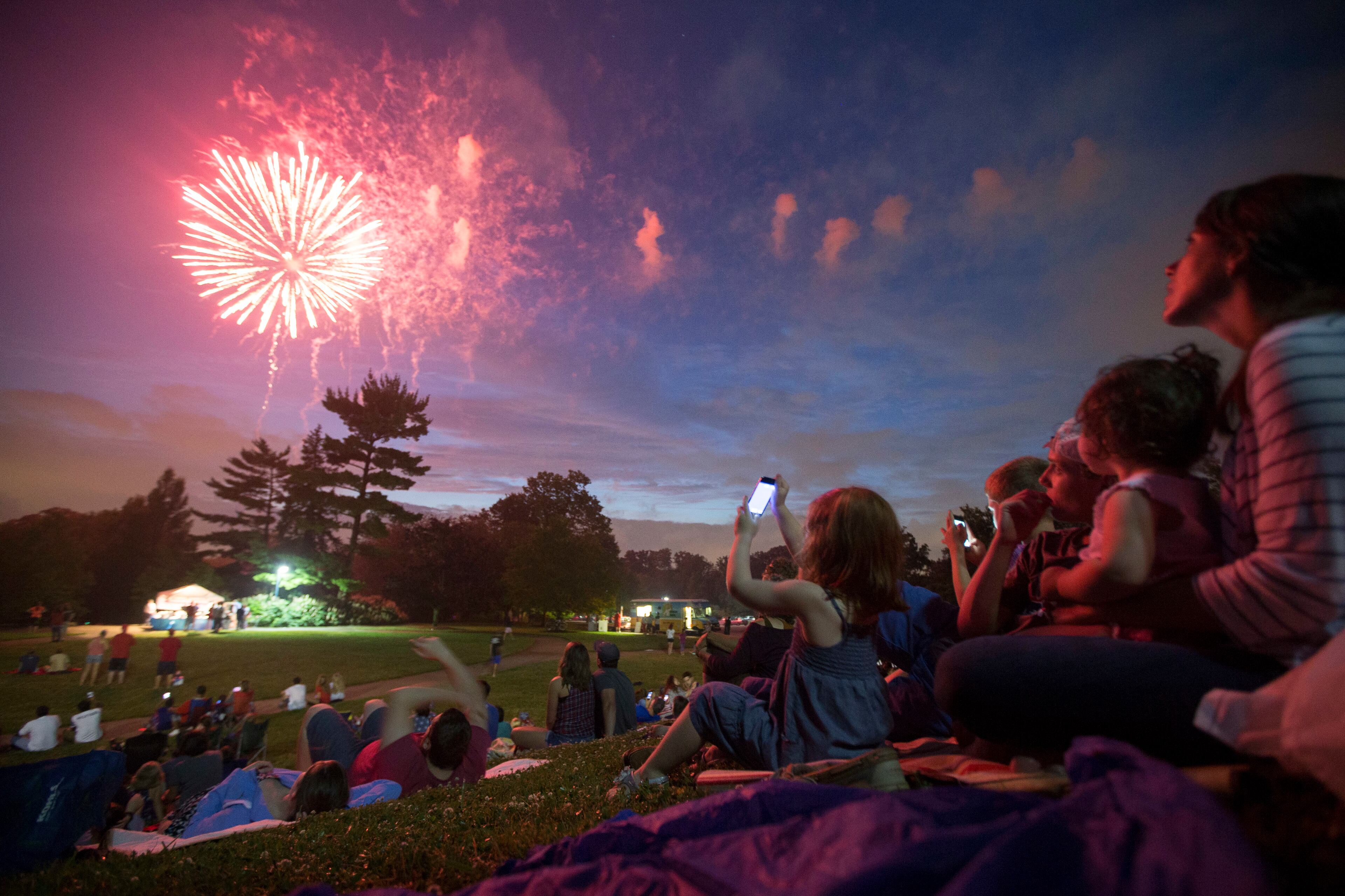 Spectators watch Fourth of July fireworks at Ault Park, Monday, July 4, 2016, in Cincinnati. (AP Photo/John Minchillo)