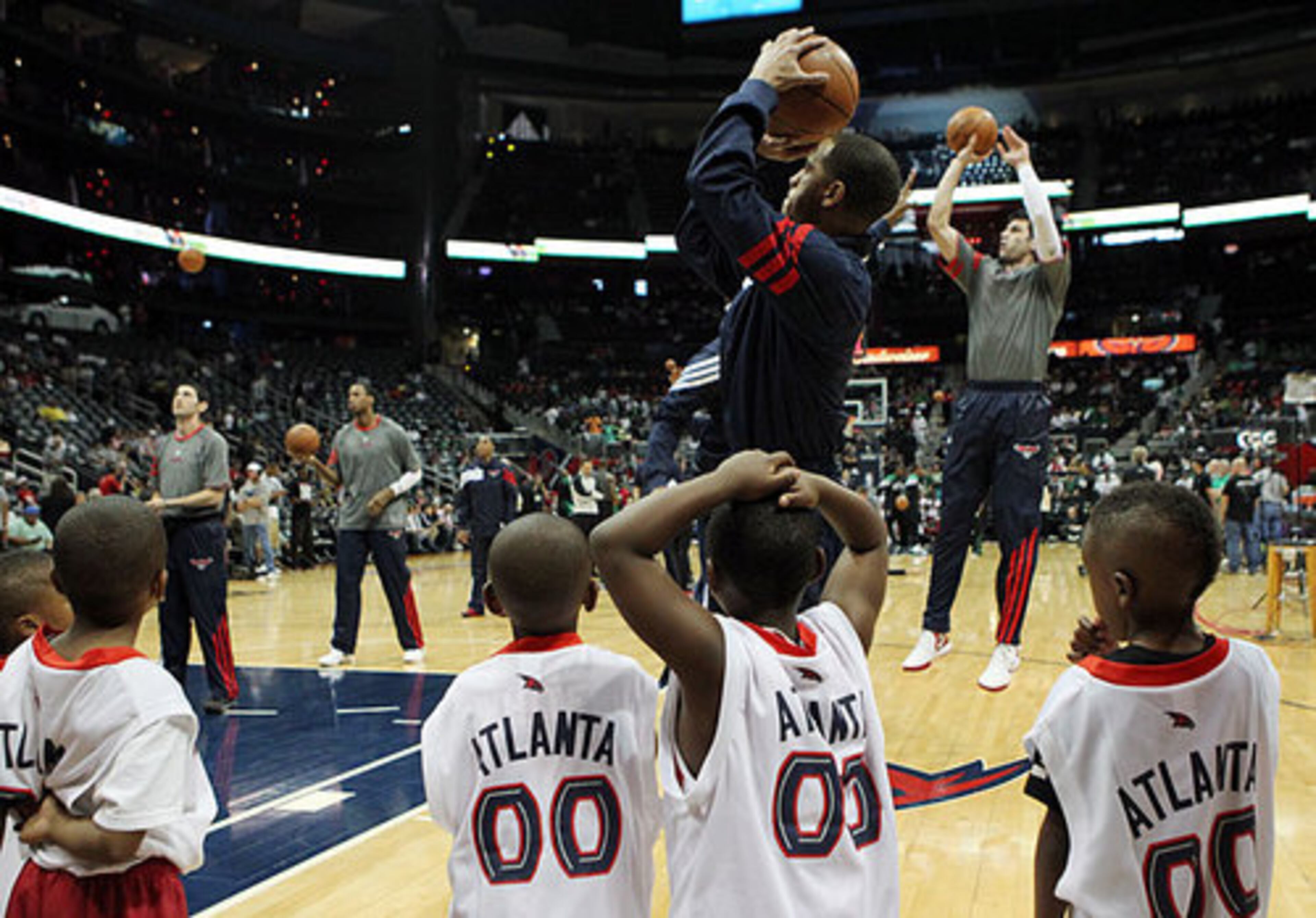 Young Atlanta Hawks fans get up close to watch their larger than life Hawks loosen up for their playoff game with the Celtics at Philips Arena in Atlanta, Sunday, April 29, 2012.